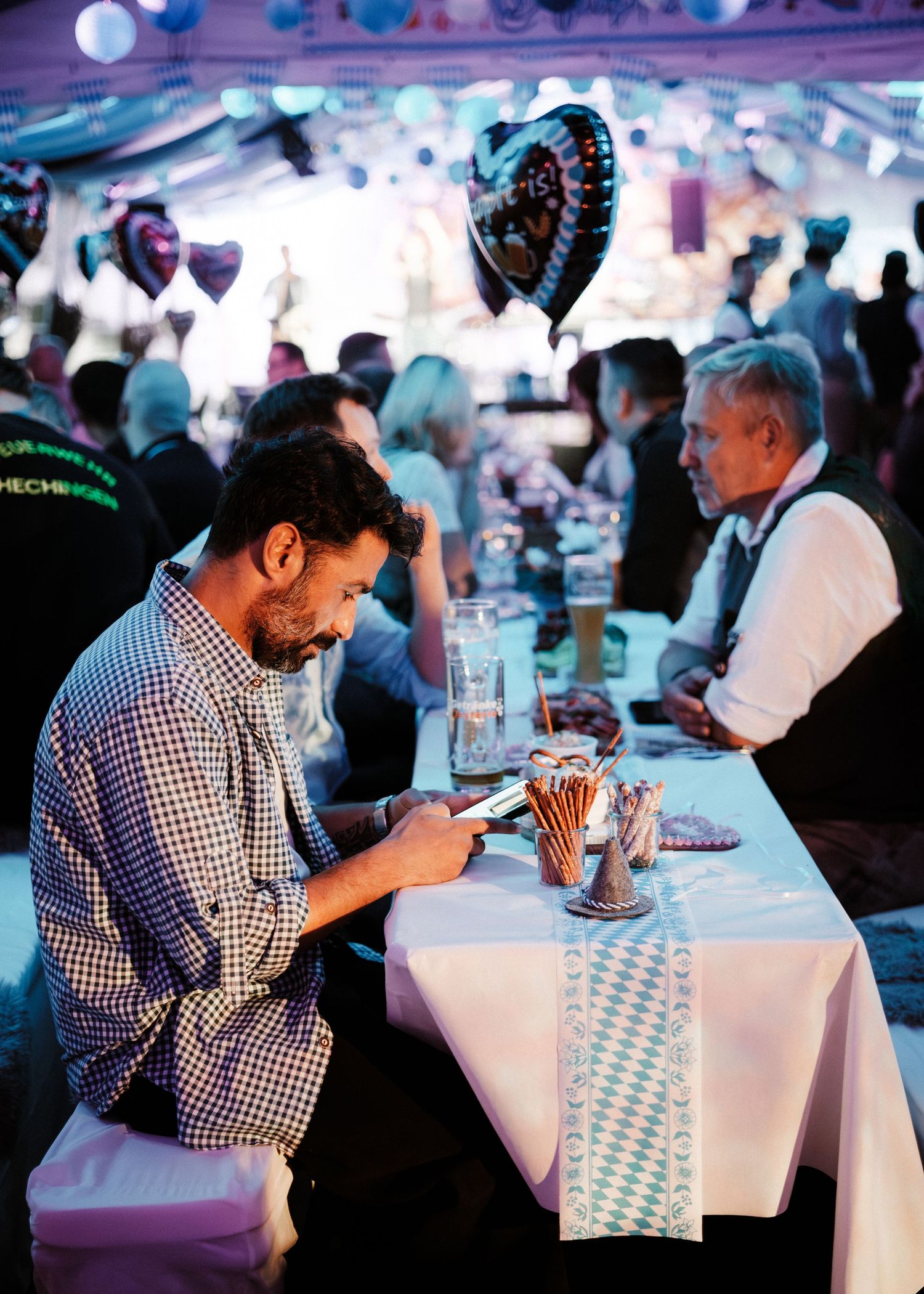 A sequence of four photos showing someone enjoying a meal at a table with white tablecloth in a crowded dining setting.