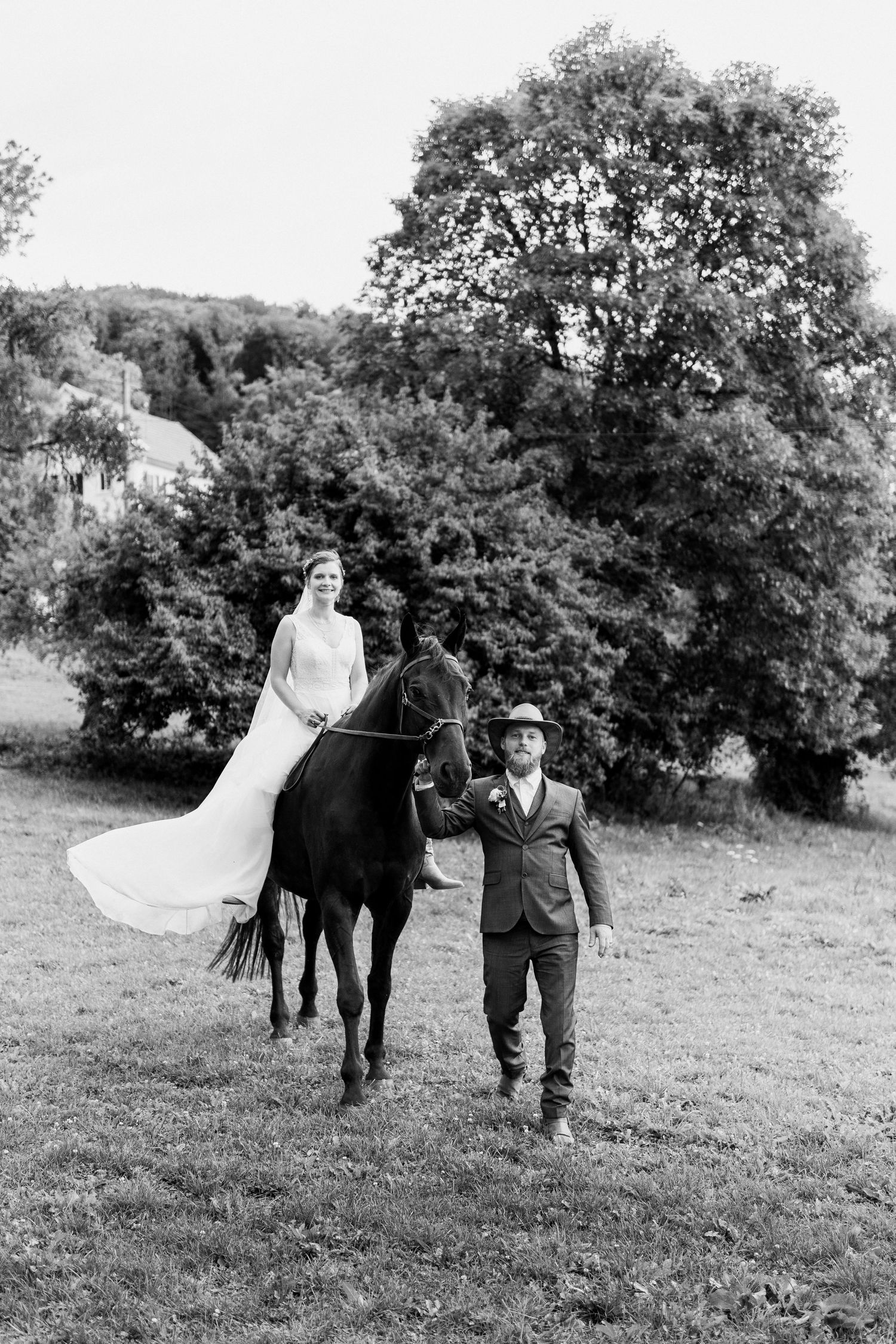 A black and white photo sequence shows a couple and their wedding party walking together across a grassy field.