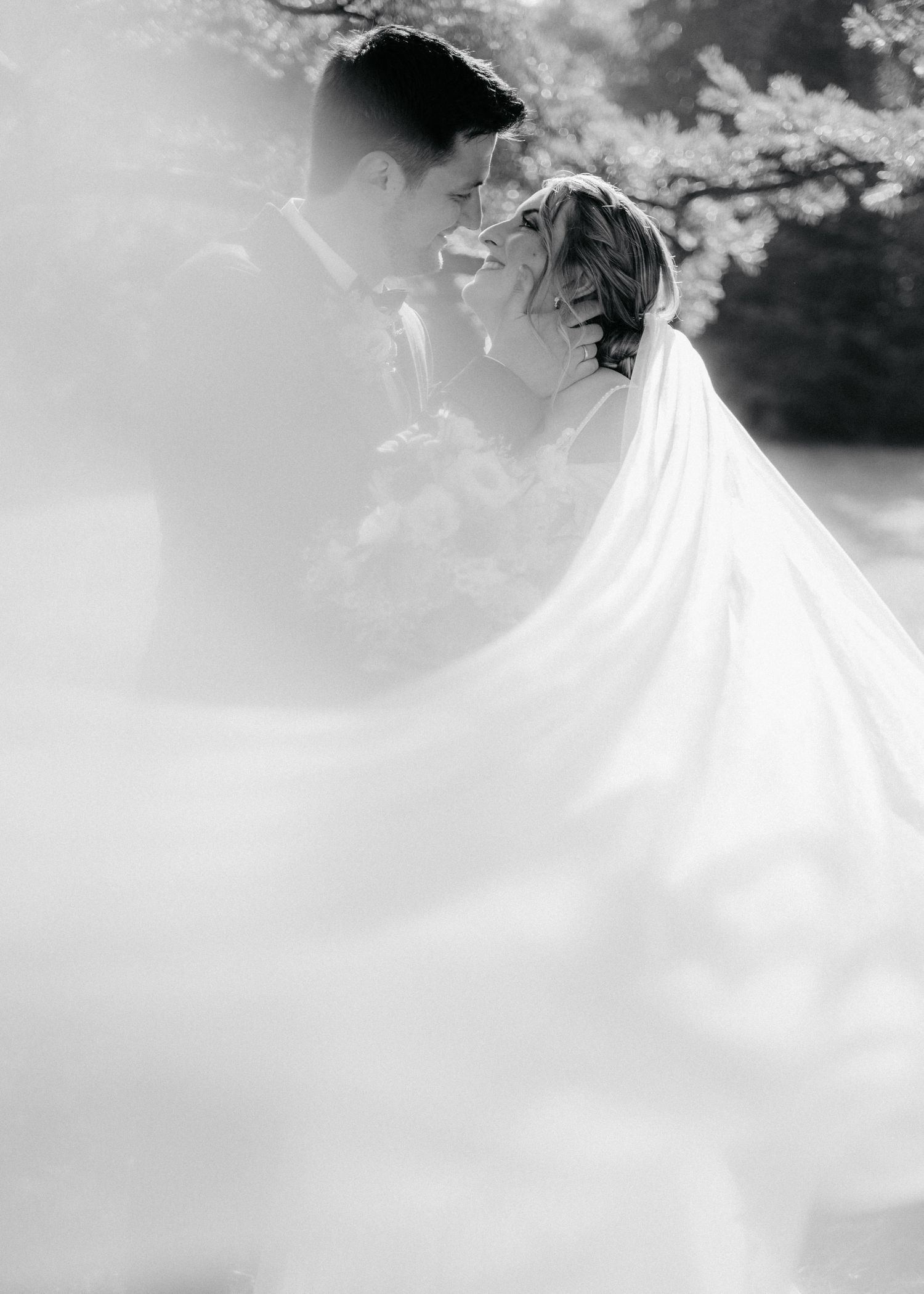 A dreamy black and white wedding photo sequence showing a bride's flowing white dress in ethereal outdoor settings.