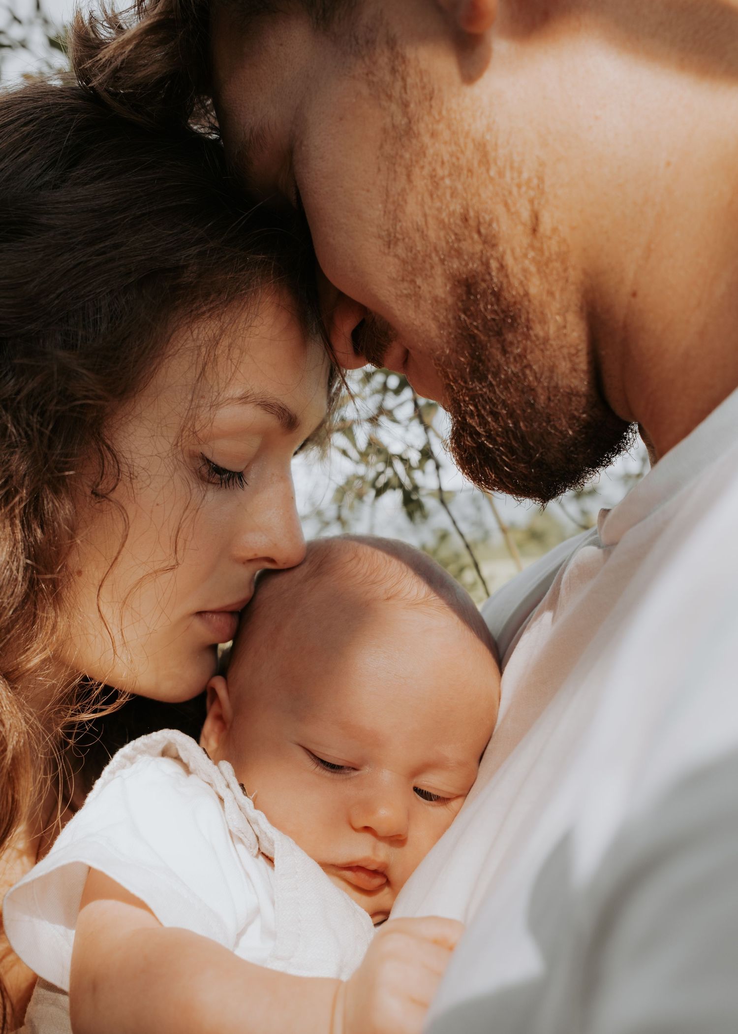 Warm-toned outdoor family portrait sequence showing intimate moments of connection.