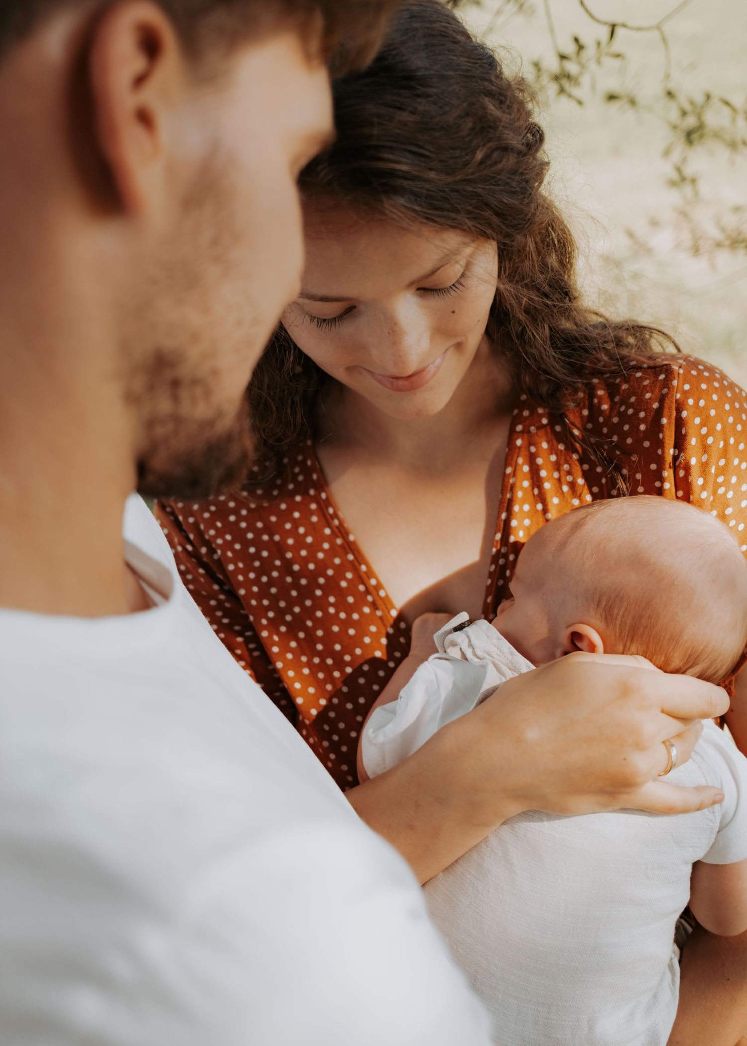 Sunlit outdoor sequence of family moments against natural backdrop.