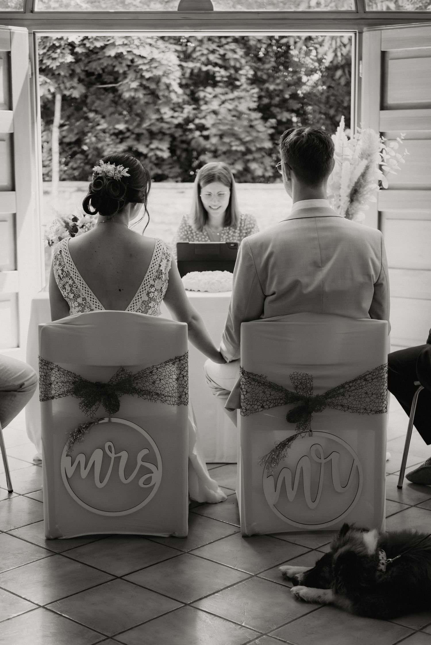 A series of black and white photos showing the back of chairs with 'Mr' and 'Mrs' signs at a wedding reception.