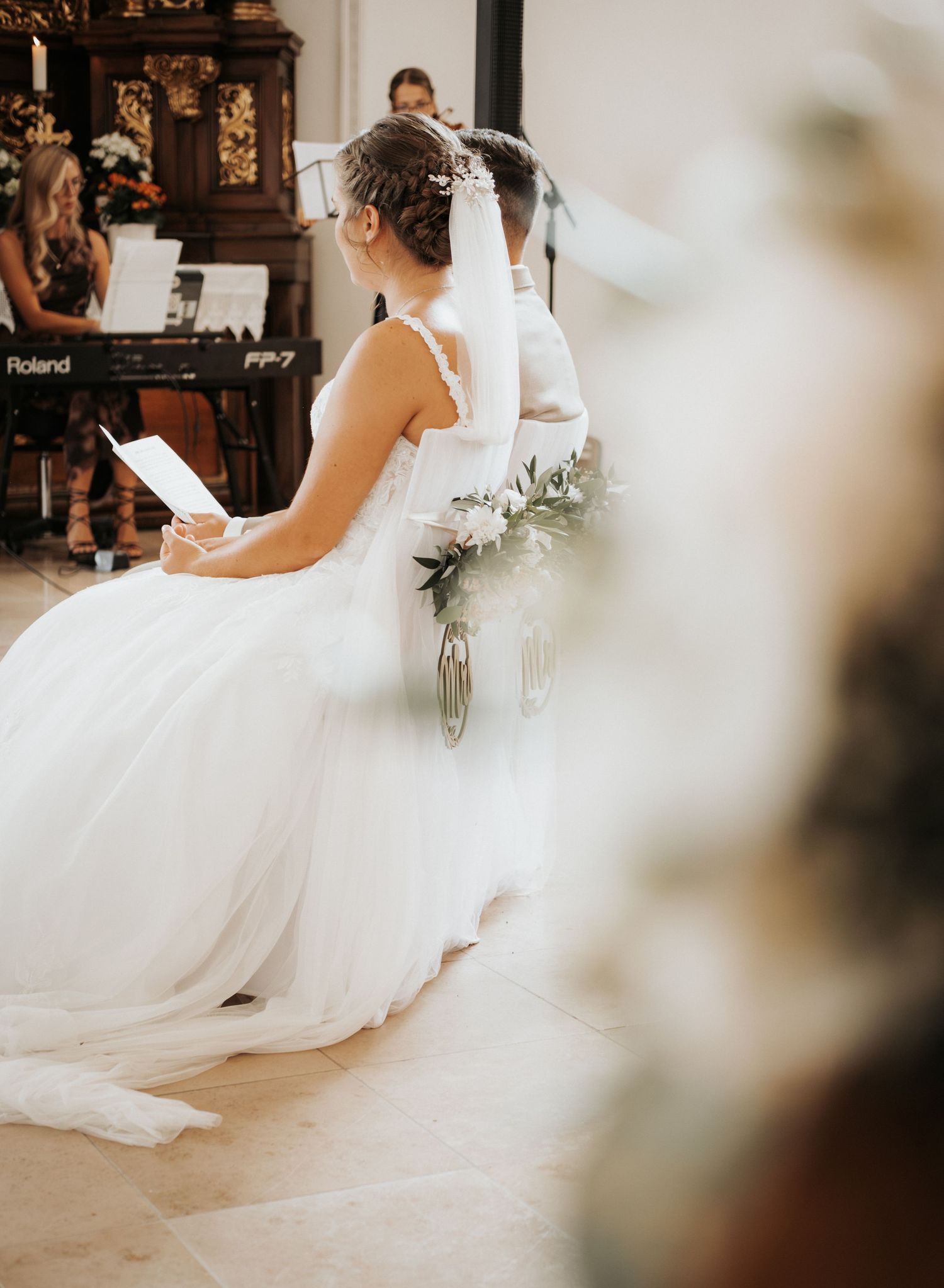 A bride in a flowing white wedding dress twirls gracefully during a dance, creating an elegant swirling motion.