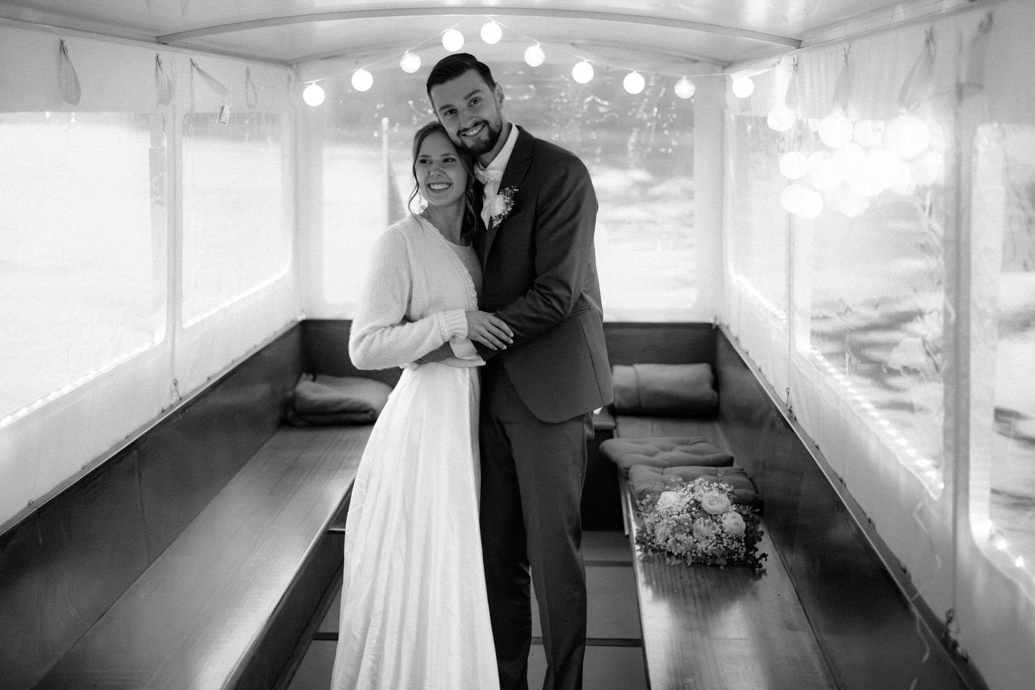 Black and white wedding photos showing romantic moments between a couple in an elegant indoor venue.