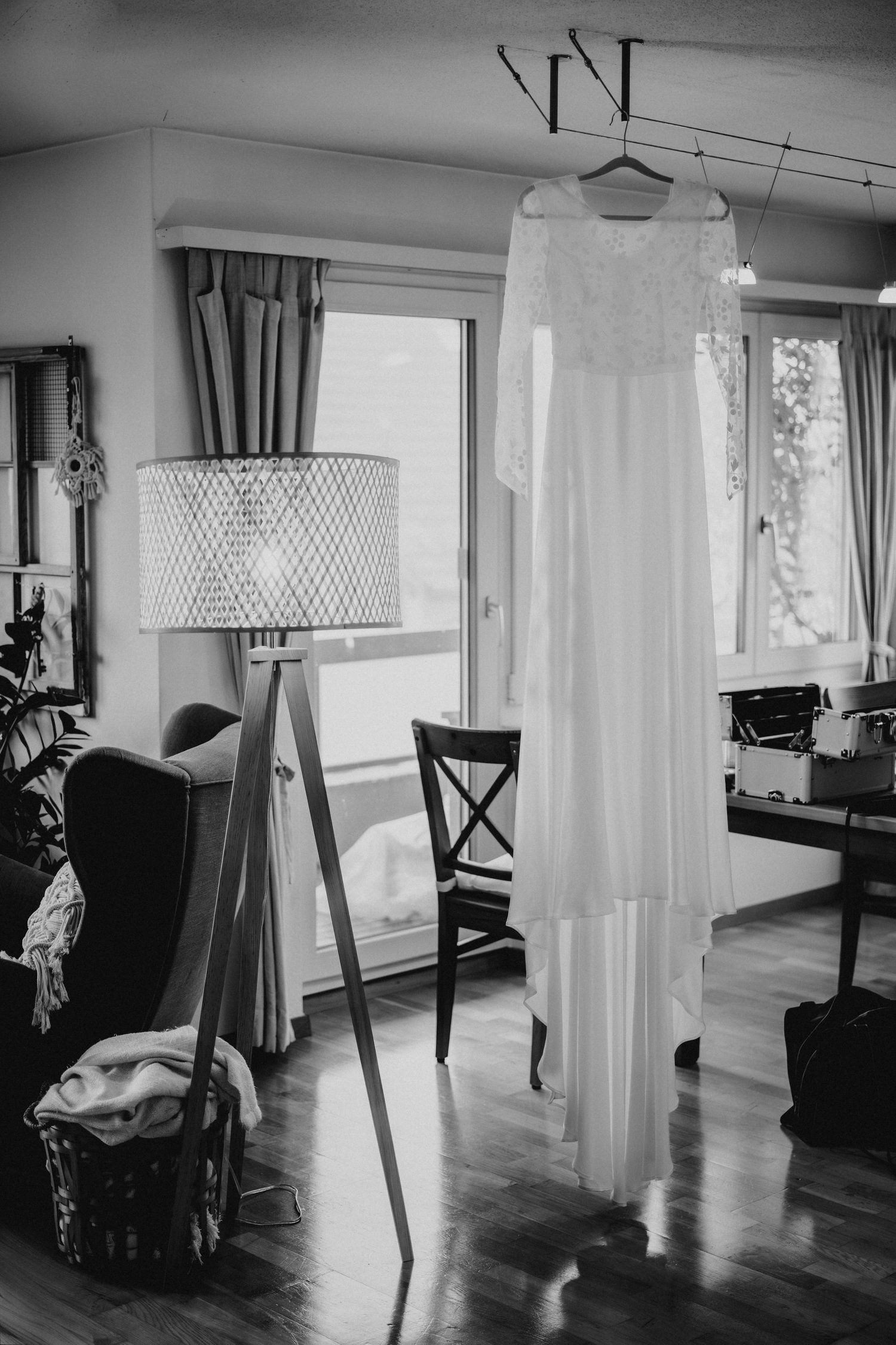 Black and white photo series showing interior views of a modern living space with hardwood floors and natural lighting.