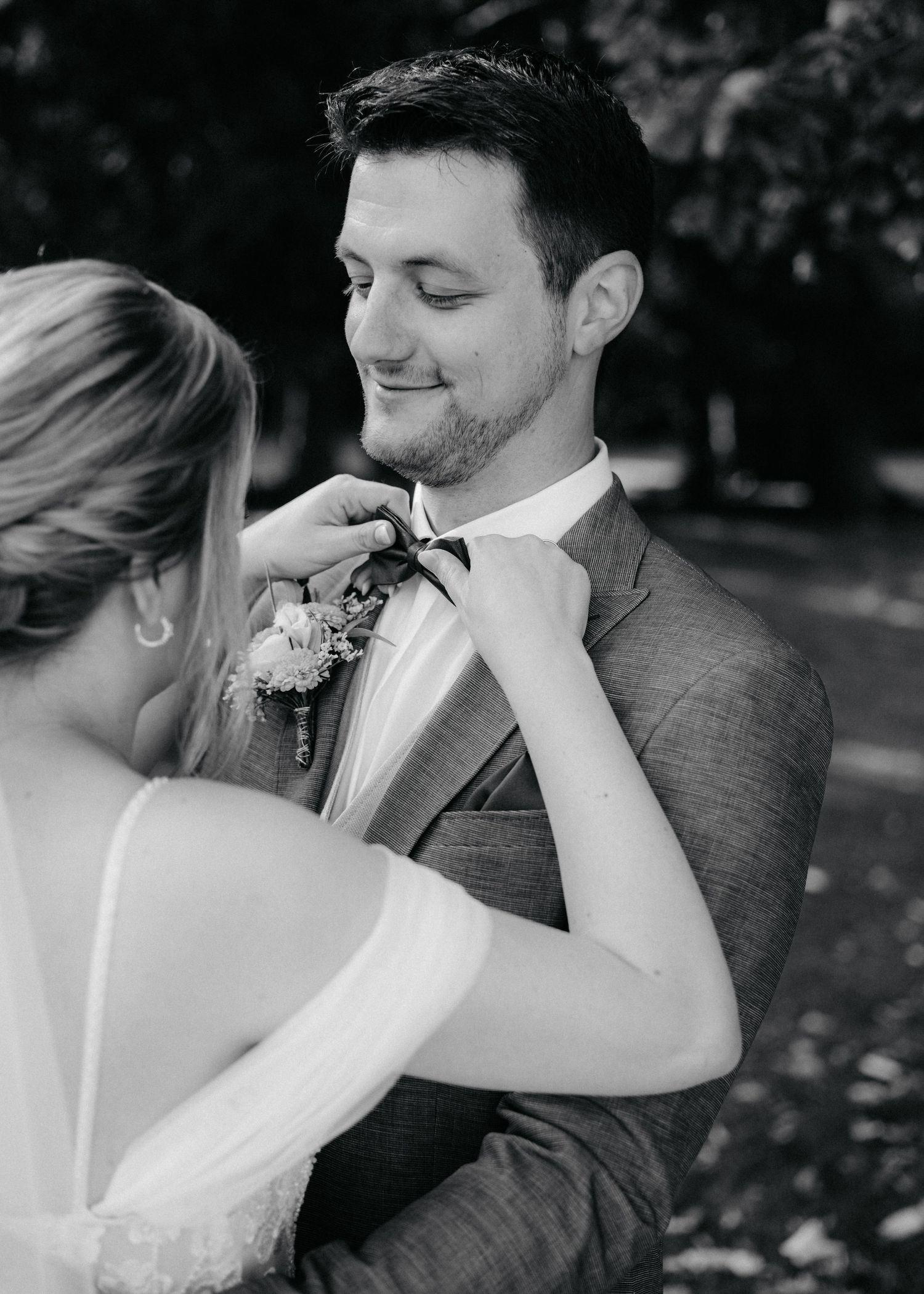 A tender black and white sequence of wedding couple moments captured outdoors.