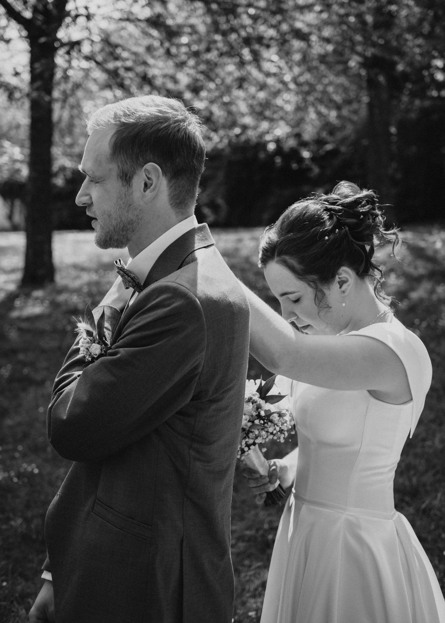 Black and white sequence of a wedding couple's emotional first look moment in a garden setting.