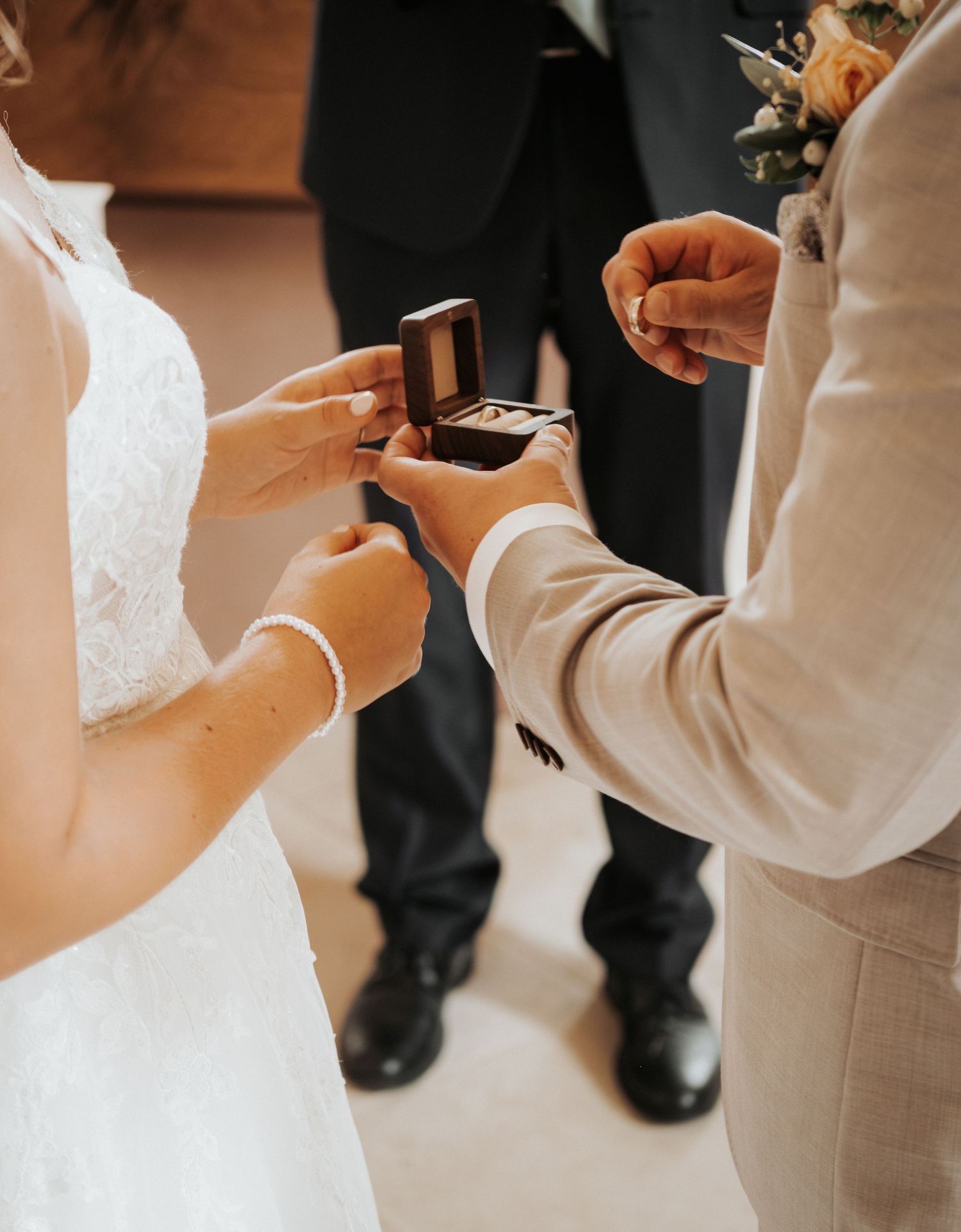 Close-up details of wedding attire and accessories during a church ceremony.