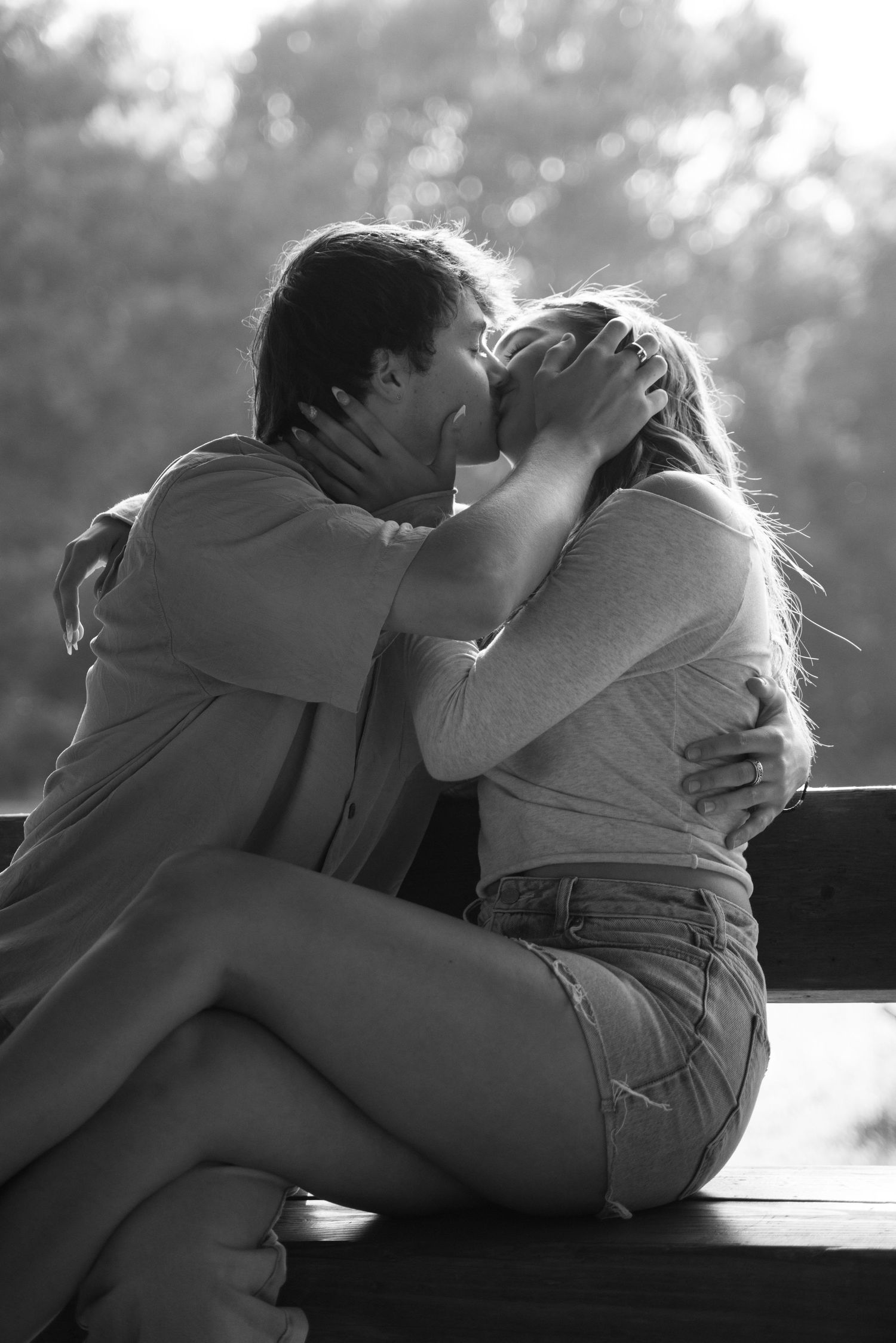 An intimate black and white moment shared between two people.