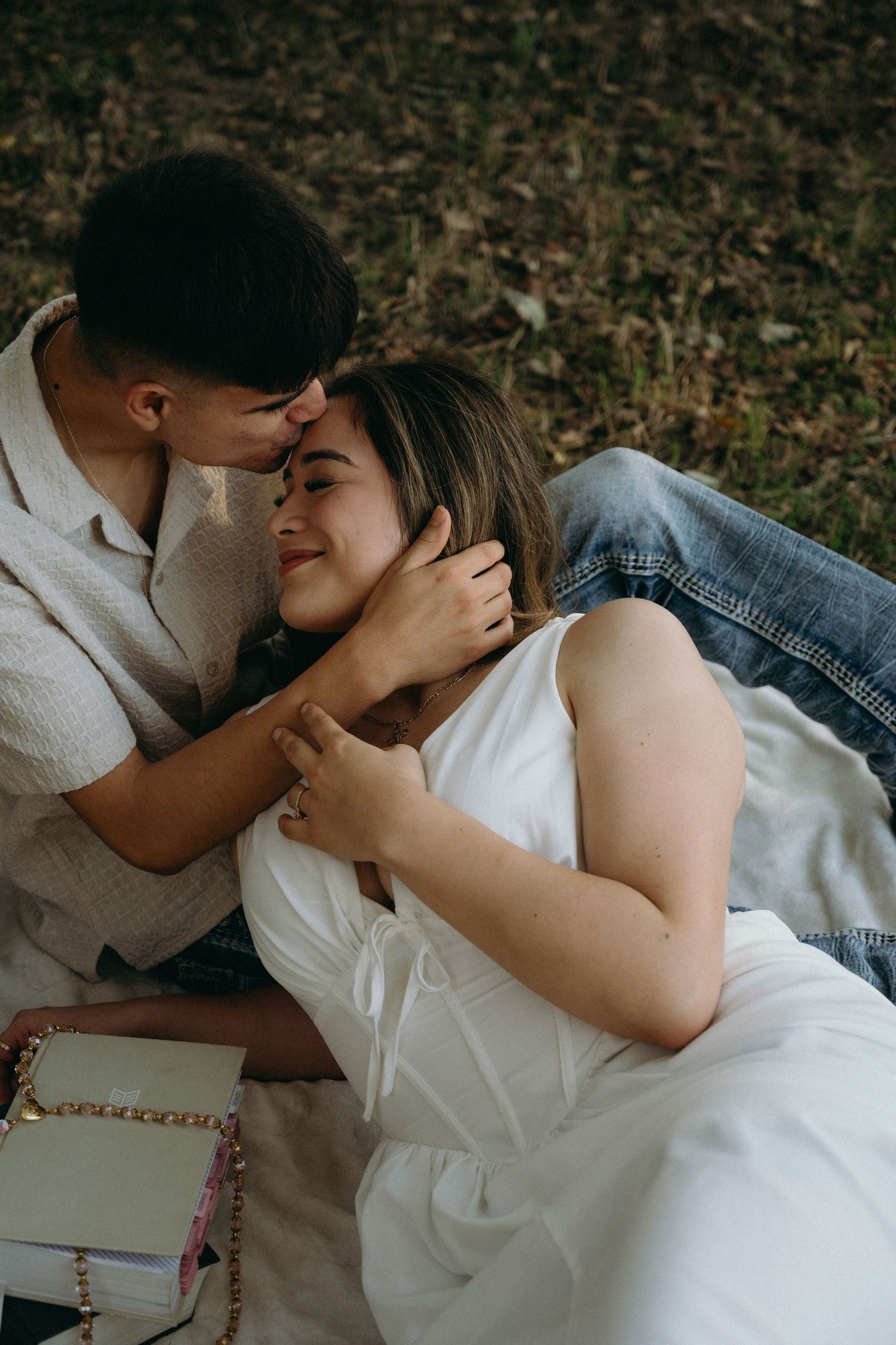 Tender moments captured between couple during intimate outdoor photo session.