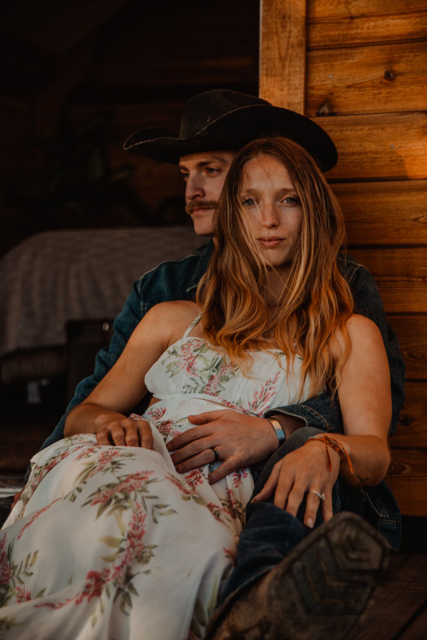 A cozy moment shared in a rustic wooden cabin with warm lighting.