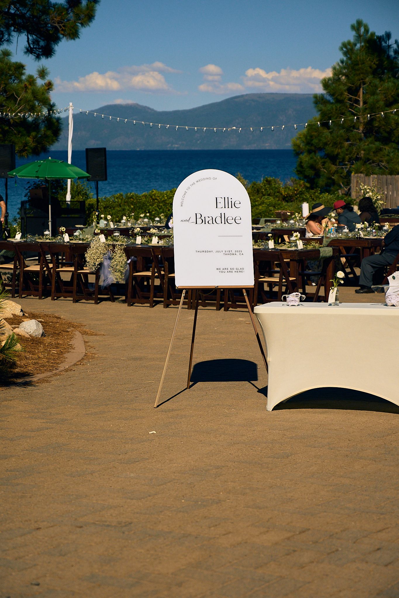 Outdoor wedding reception sign for Ellie and Bradlee with lake and mountain views at Lake Tahoe venue.