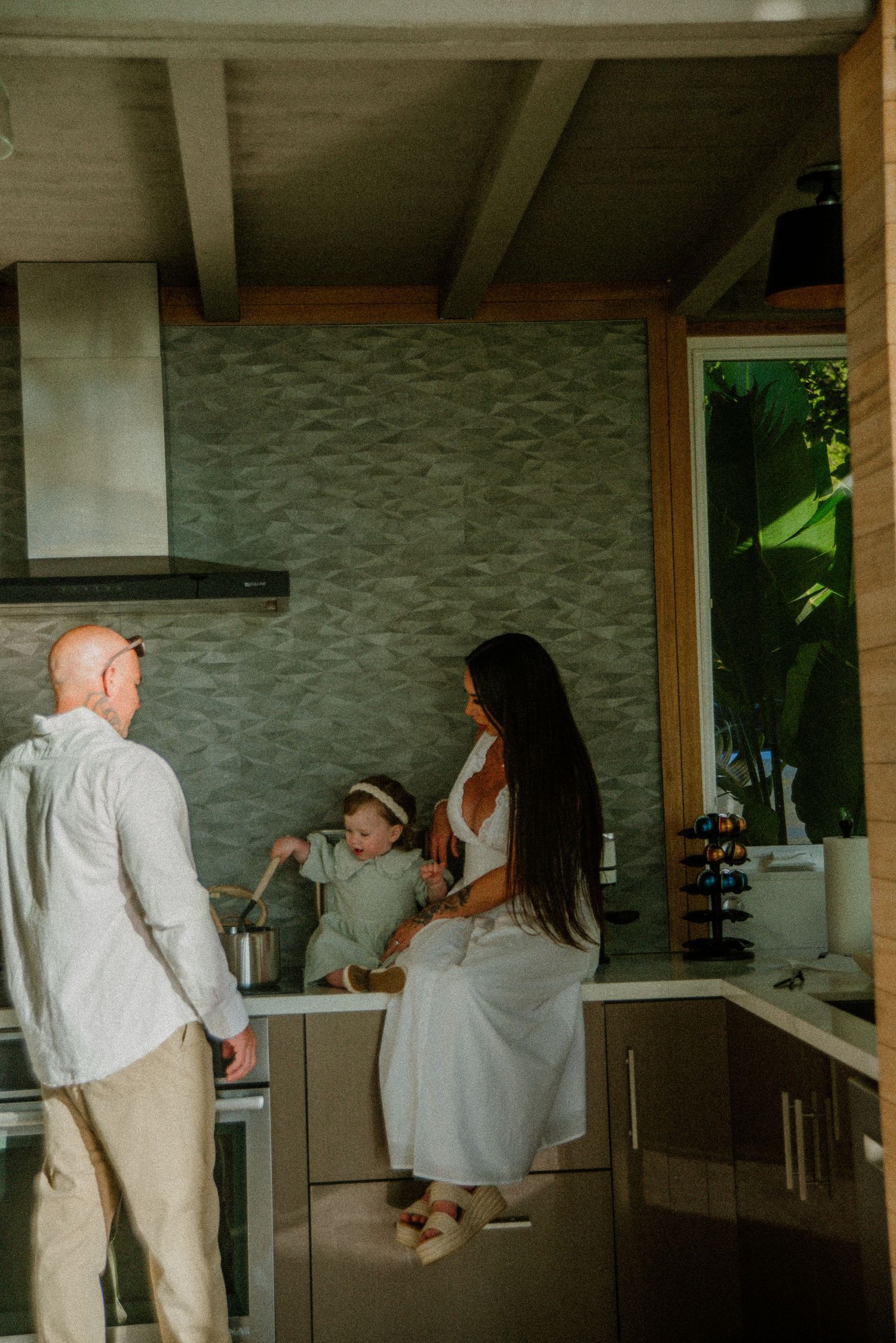 Progressive shots of two people sharing a lighthearted moment in a contemporary kitchen space.