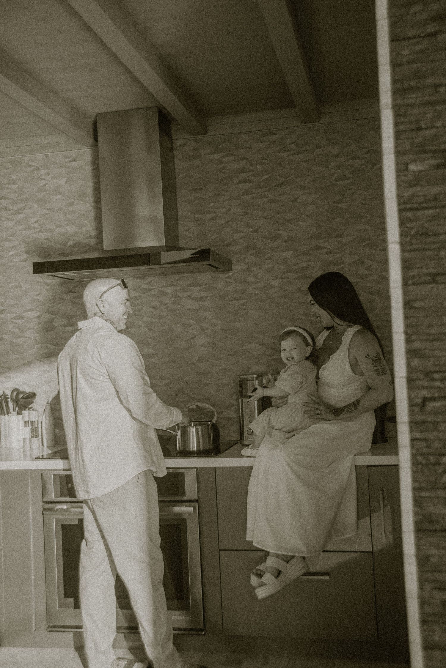 A series of candid kitchen moments showing playful interaction between two people in a home setting.