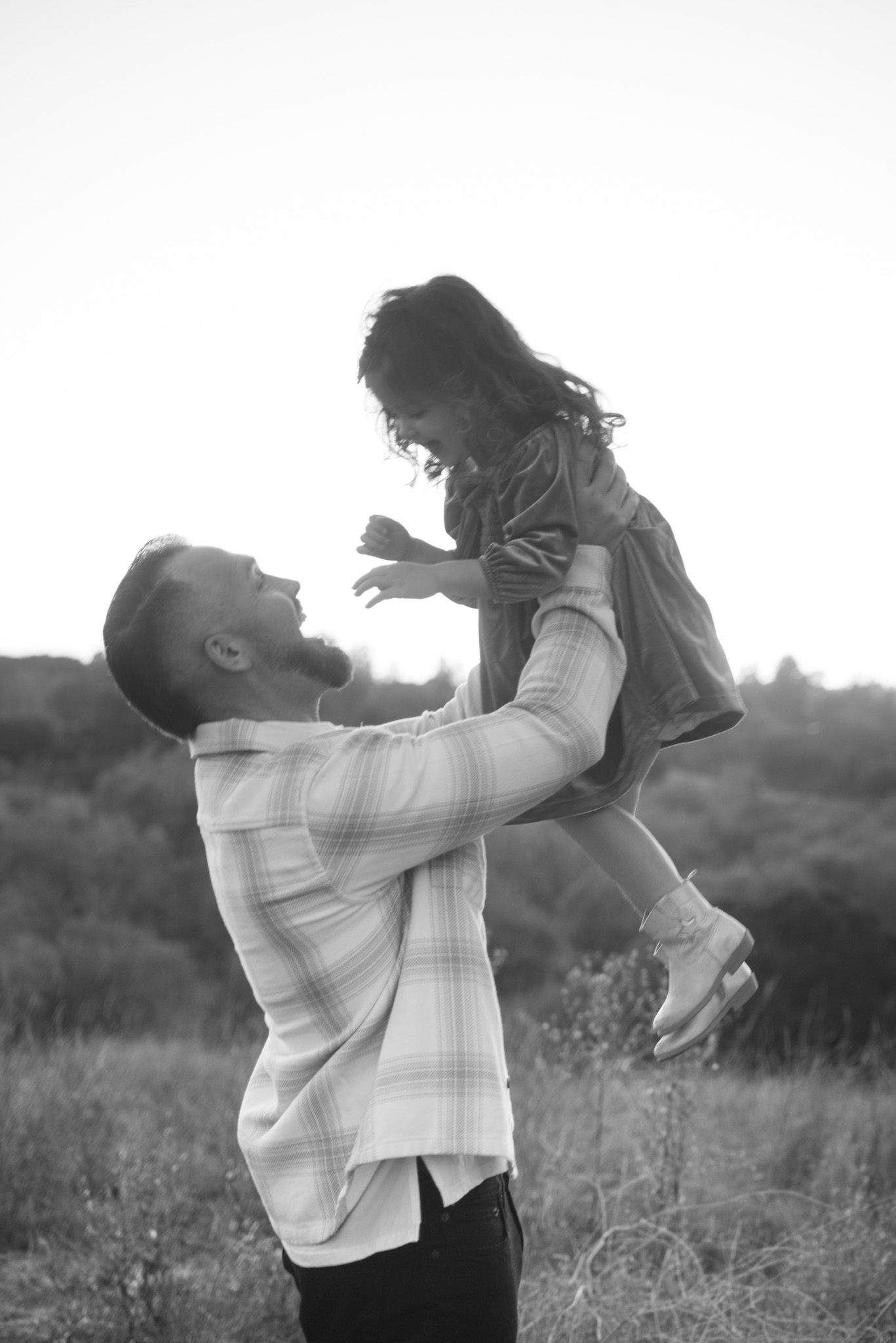 Black and white sequence of joyful interaction in an outdoor setting.