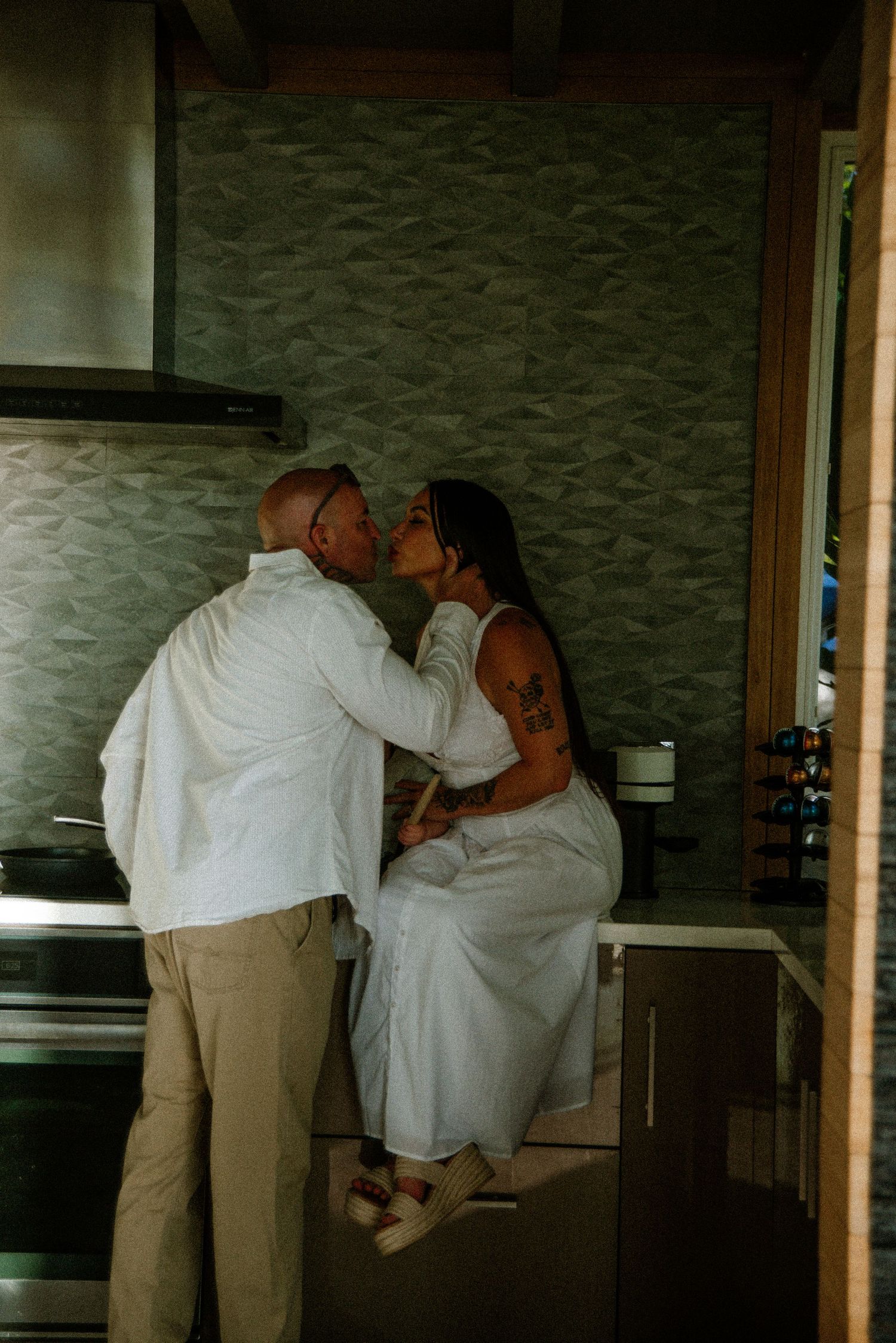 Three sequential photos capturing tender interaction in a modern kitchen interior.