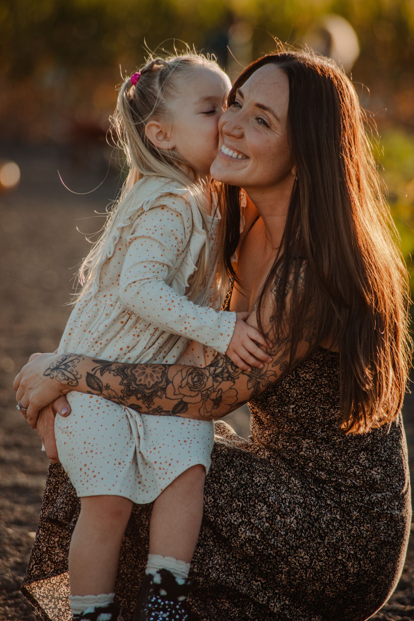 A sweet moment between parent and child in golden sunset light.