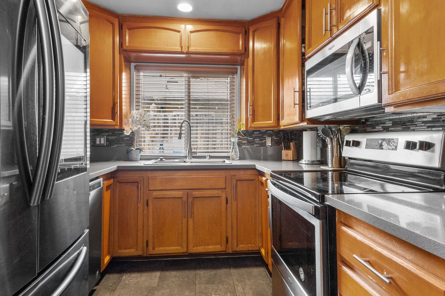 Traditional kitchen with honey oak cabinets and stainless steel appliances.