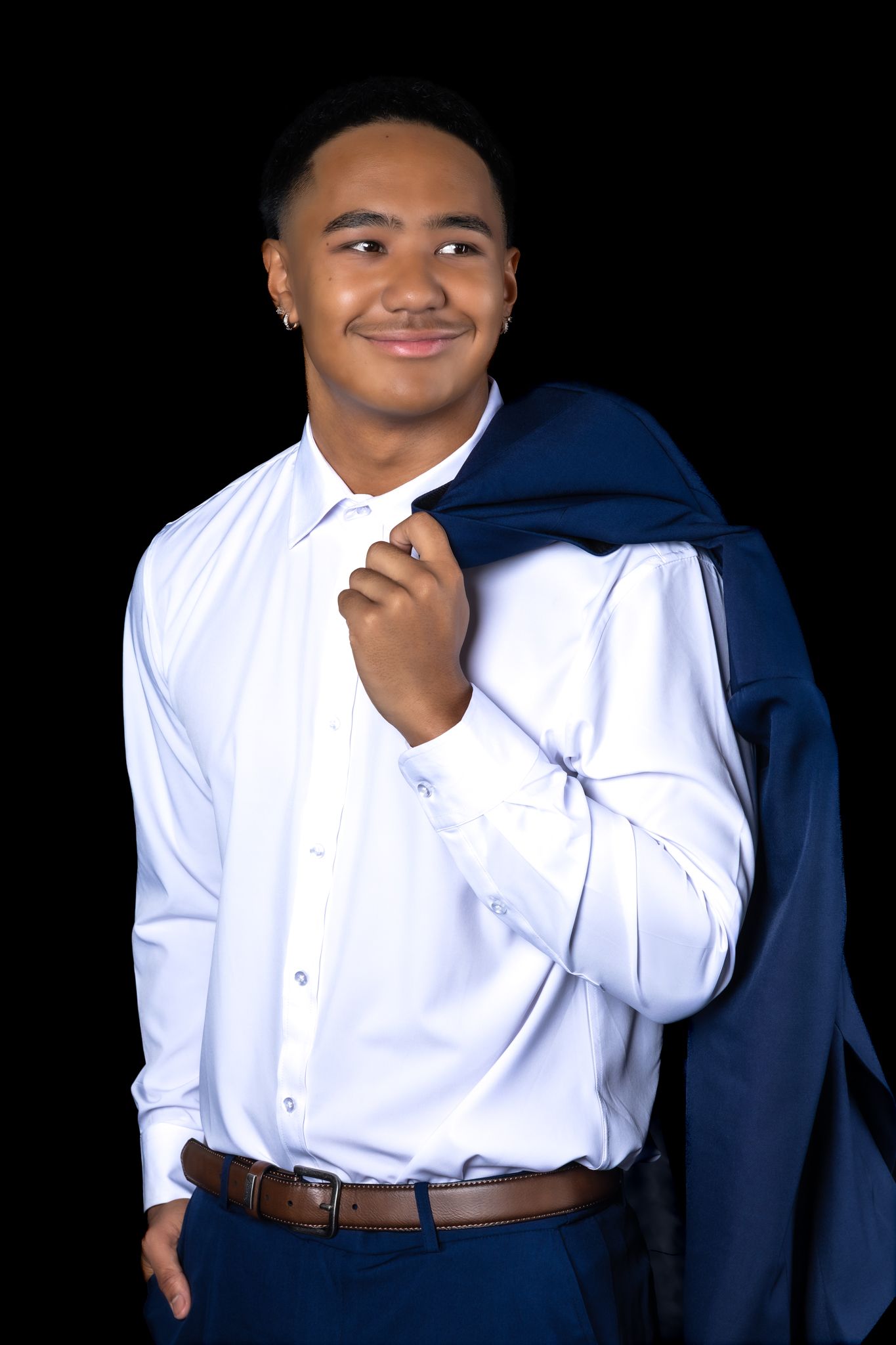 Professional studio portrait series showing different poses in a white button-down shirt against a dark background.