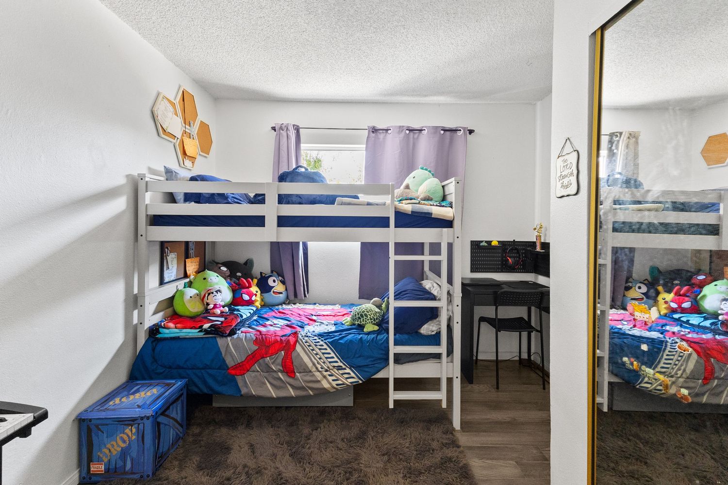 Dormitory-style room with multiple bunk beds and white walls.