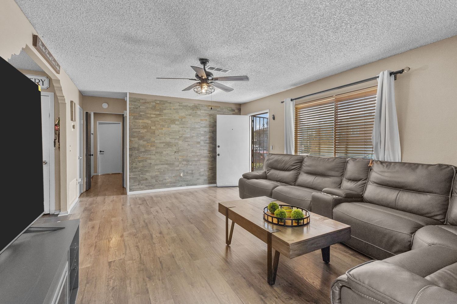 Living room interior featuring comfortable sectional sofa and modern furnishings.