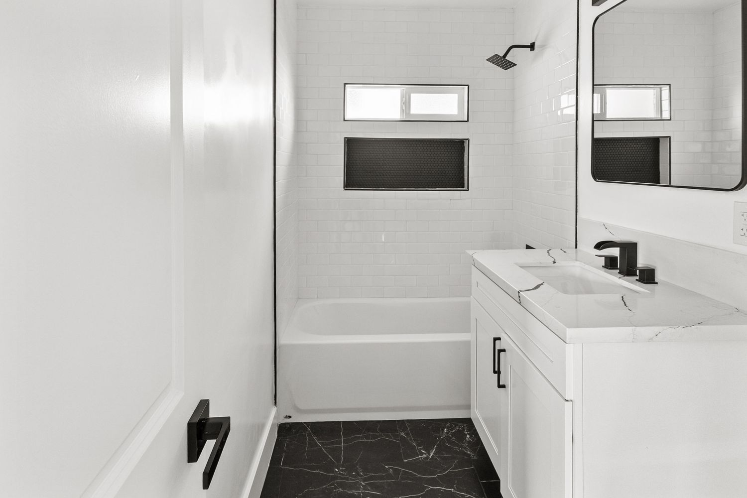 Clean white interior bathroom with modern fixtures and minimalist design.