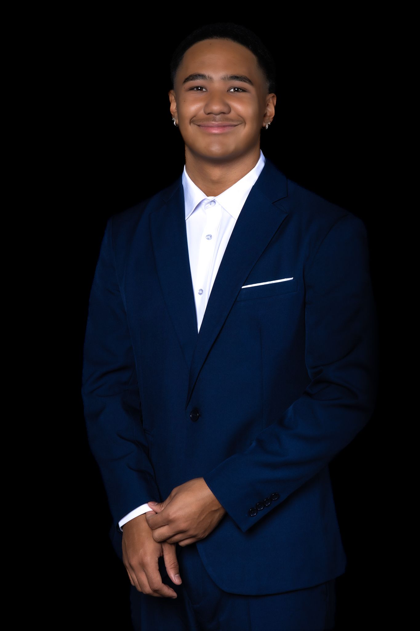 Professional portrait series showing a person in a navy blue suit and white shirt against a black background.