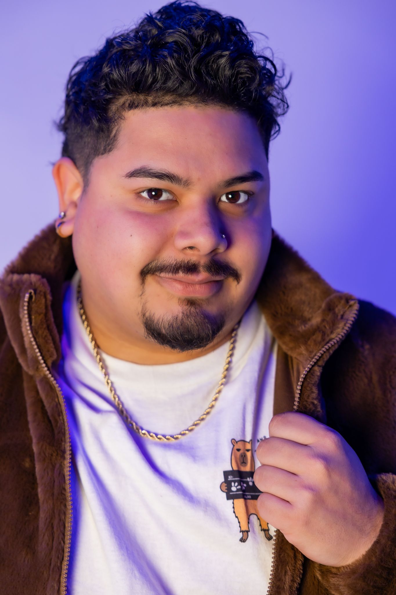Portrait series of person wearing brown jacket and white shirt against purple background with various poses and expressions.