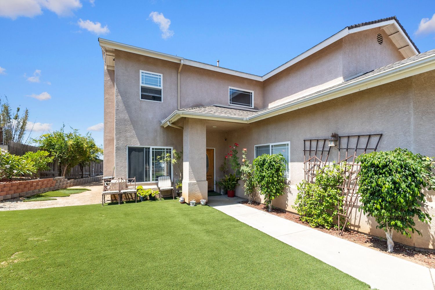 Exterior view of single-story home with well-maintained lawn and landscaping.