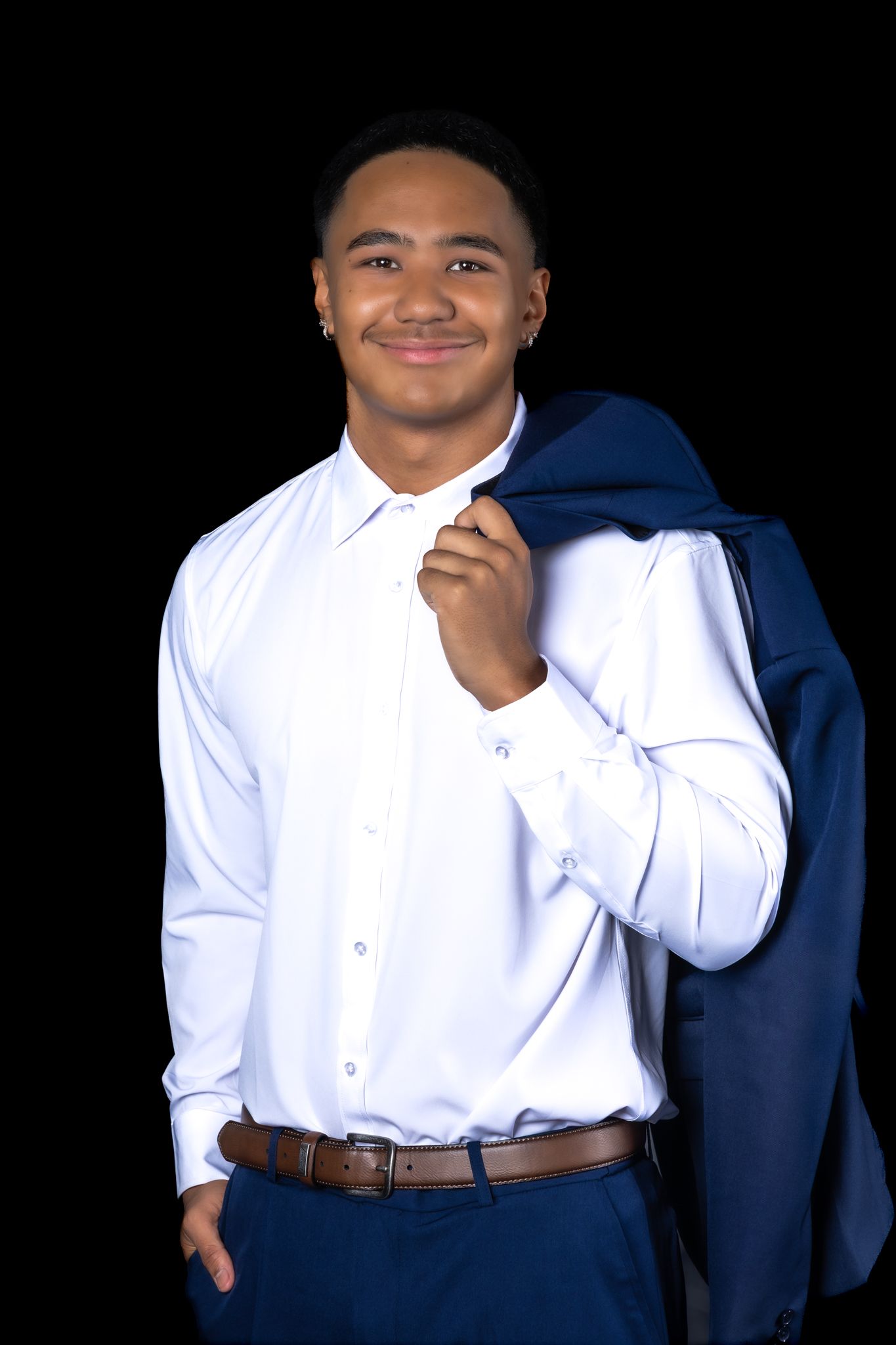 Studio portraits featuring someone wearing a crisp white button-down shirt with a navy blazer.