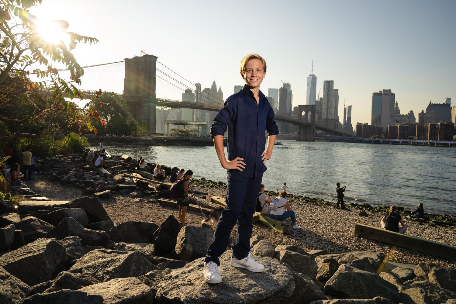 A series of photos showing someone walking along a rocky waterfront with the New York City skyline in the background.