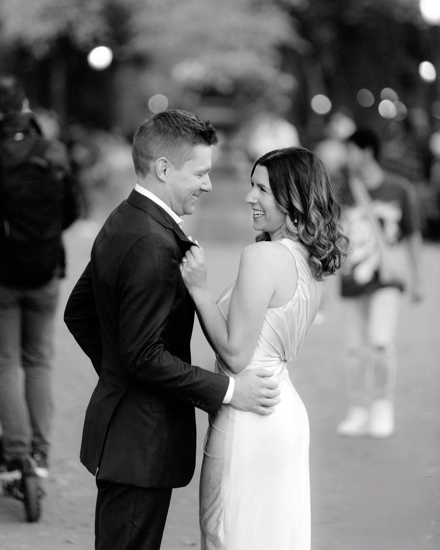 Black and white portrait of couple sharing intimate moment at evening celebration.
