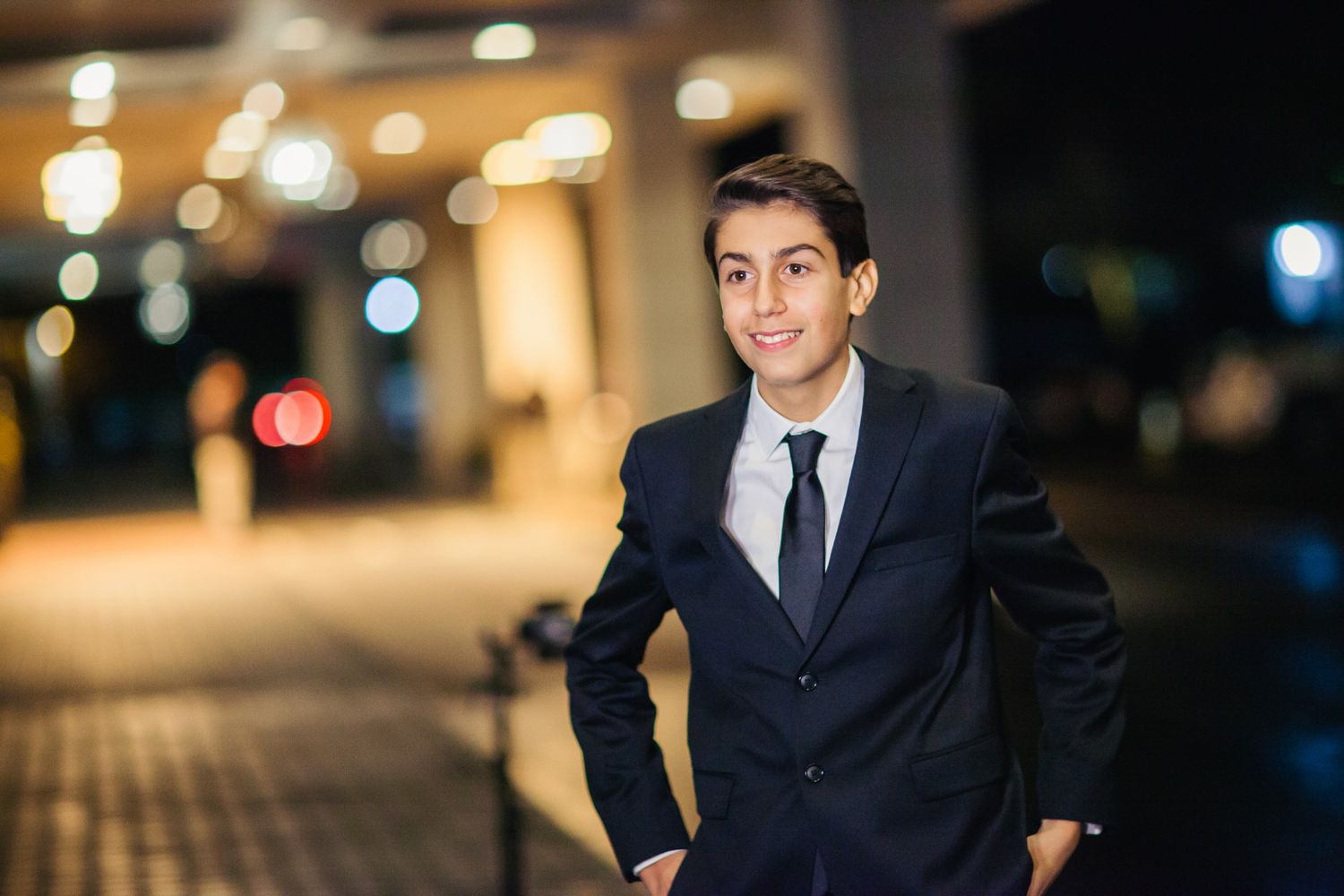 Nighttime portrait with bokeh lights creating an elegant atmosphere.