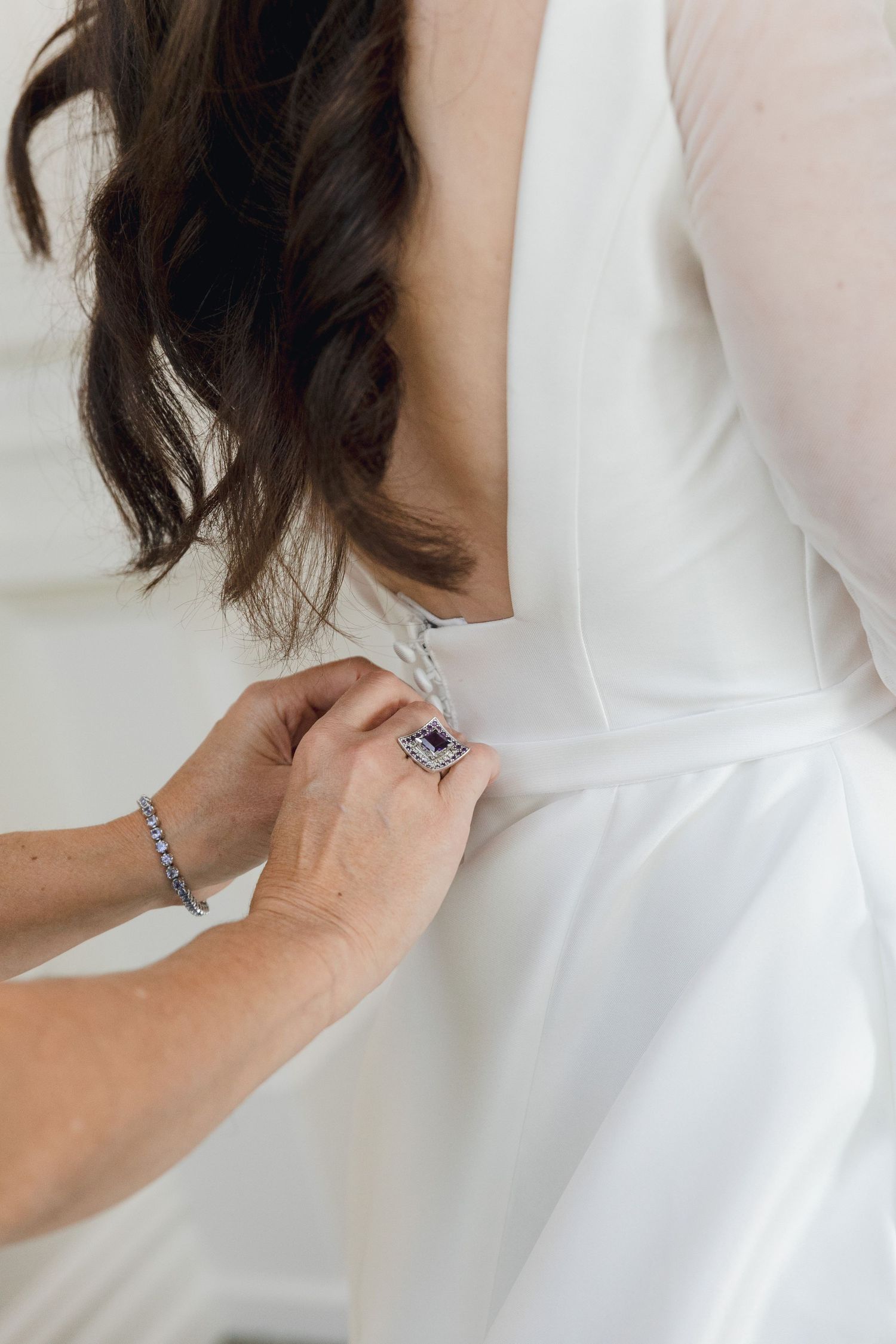 Close-up of white wedding dress details and fabric.