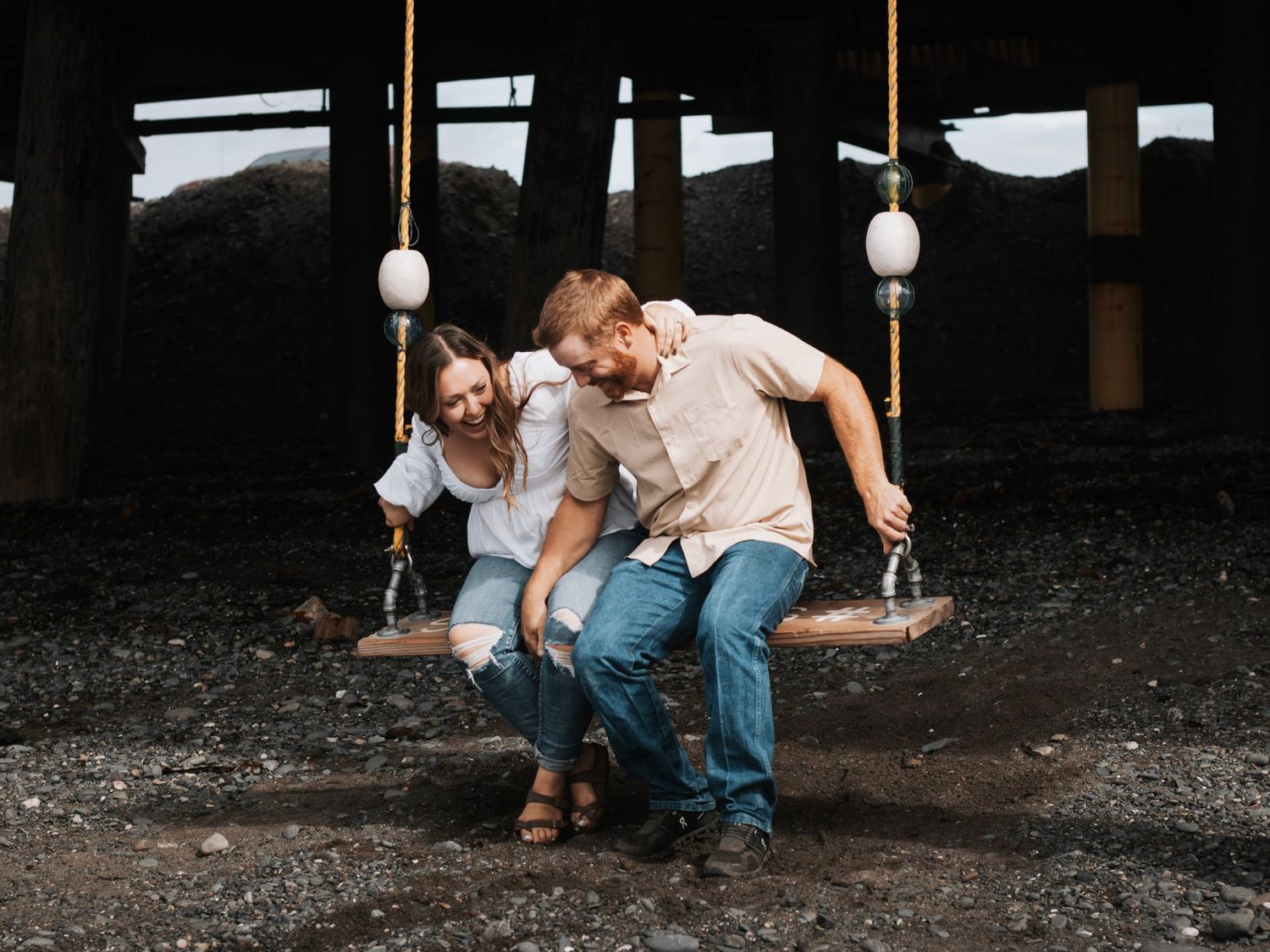 Romantic photoshoot under covered pier with moody lighting in Alaska