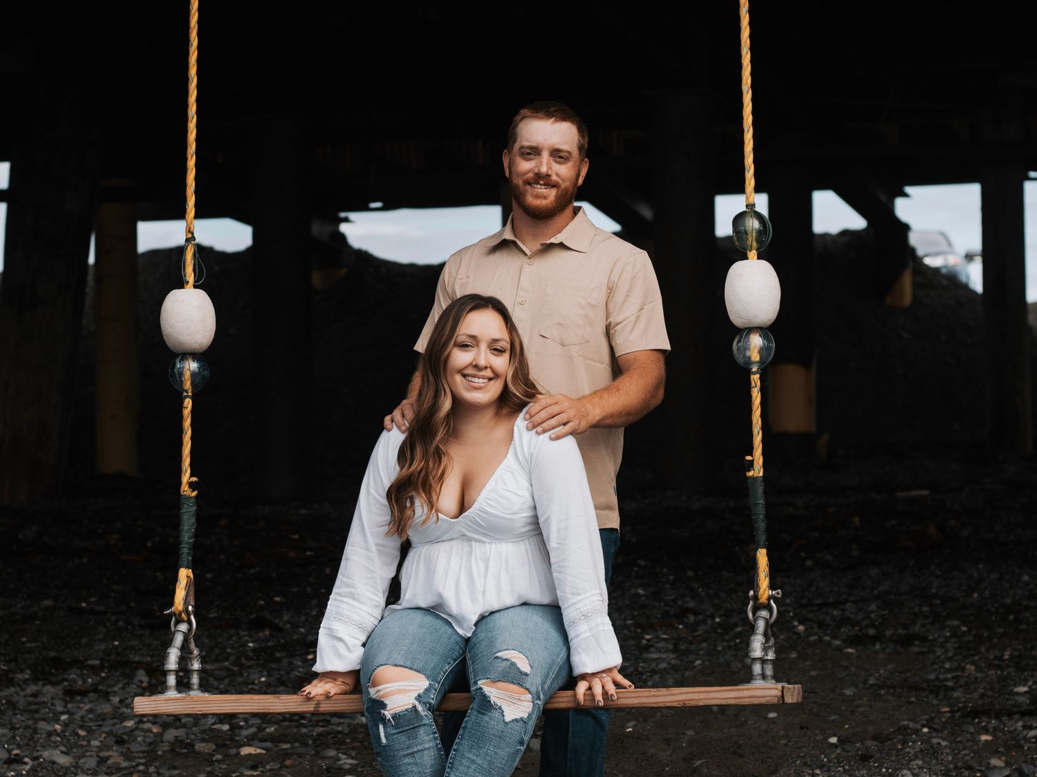 Candid moments captured on rustic wooden swing by the beach in Alaska