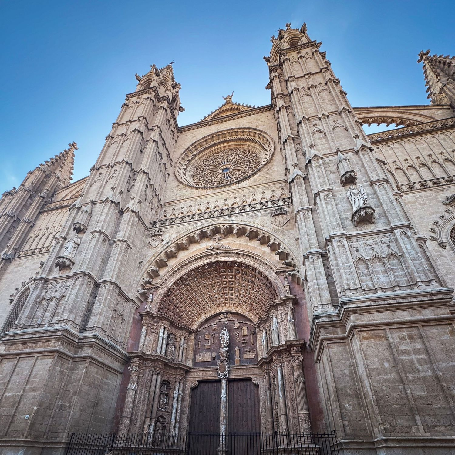 A panoramic series showing different angles of an ornate gothic cathedral facade with intricate stone carvings and arches.