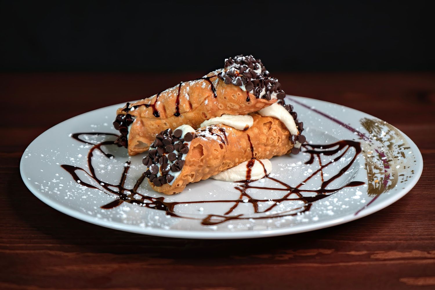 Professional food photography of two cannolis plated for a Pahrump Nevada restaurant dessert menu by Oasis Digital.