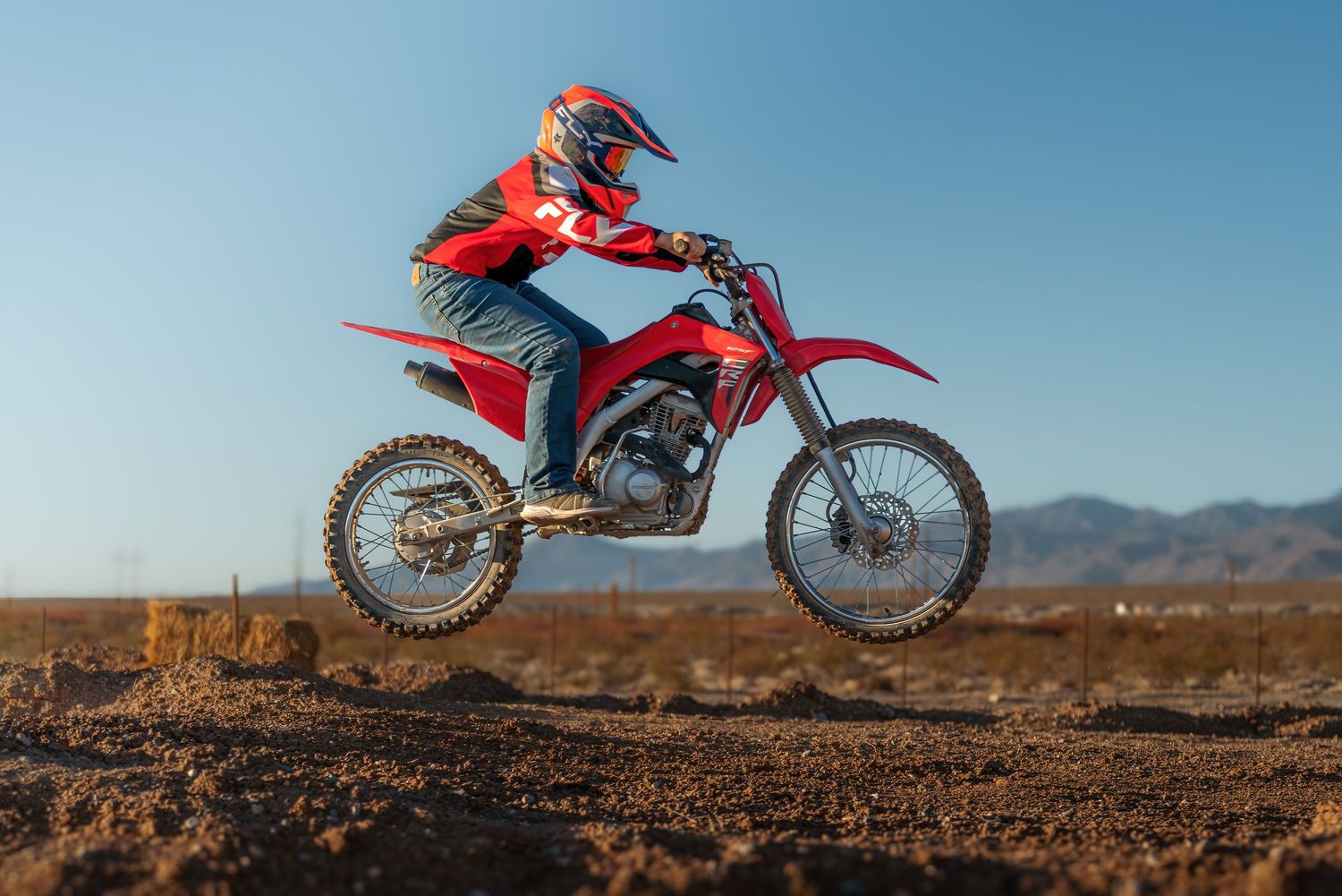 Professional off-road photography of a dirt bike rider mid-jump by Oasis Digital.