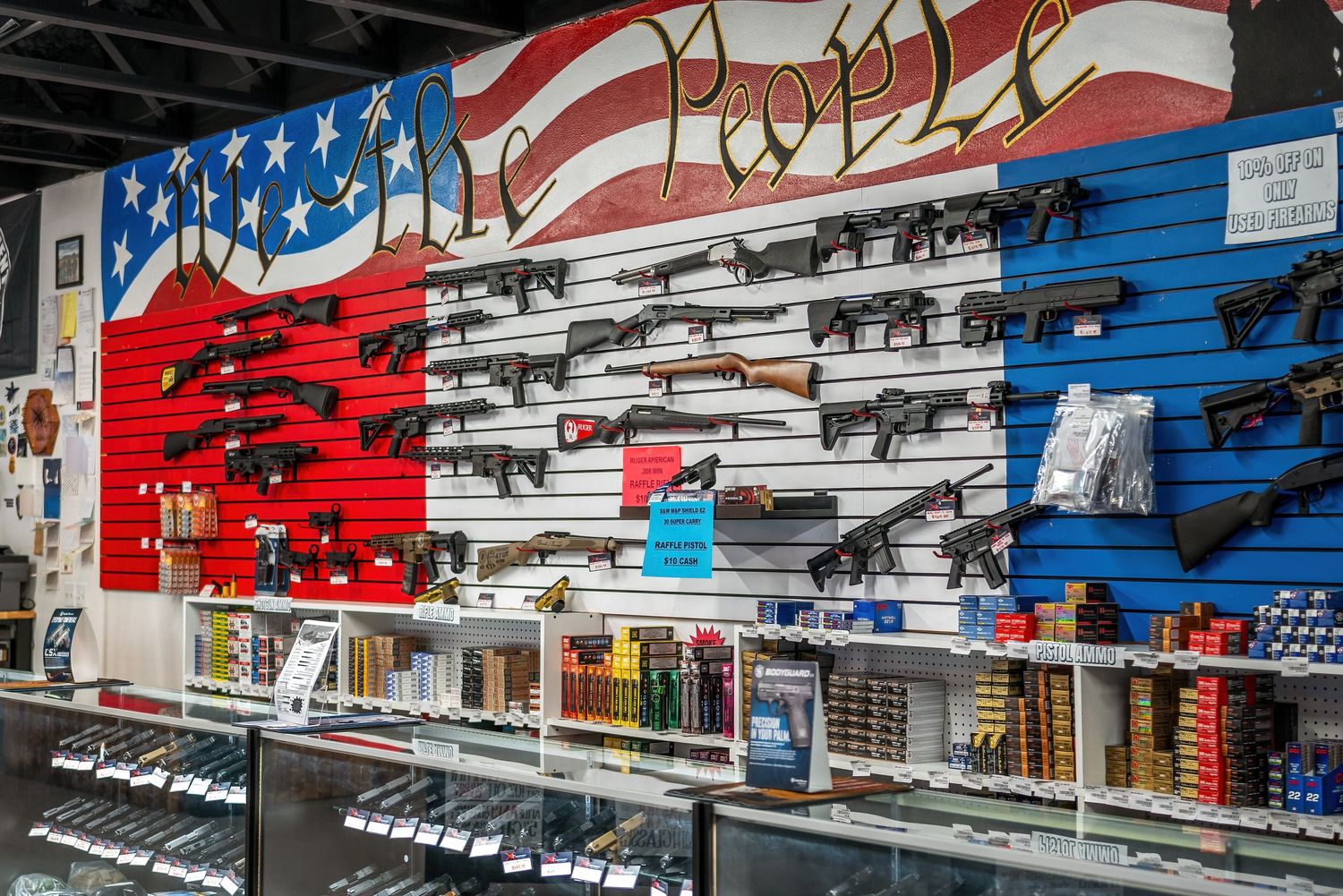 Interior photography of a Pahrump Nevada gun store showing firearms displays and counter area by Oasis Digital.