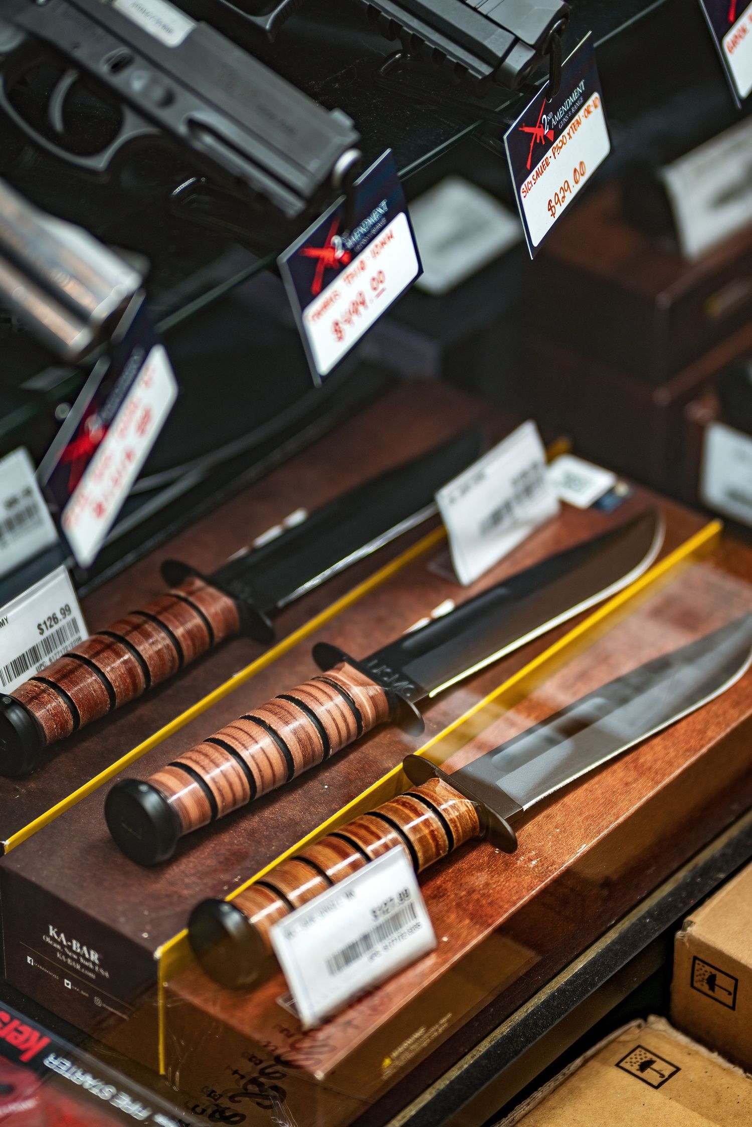 Close-up product photography of handguns and accessories inside a Pahrump Nevada shooting range retail space by Oasis Digital.