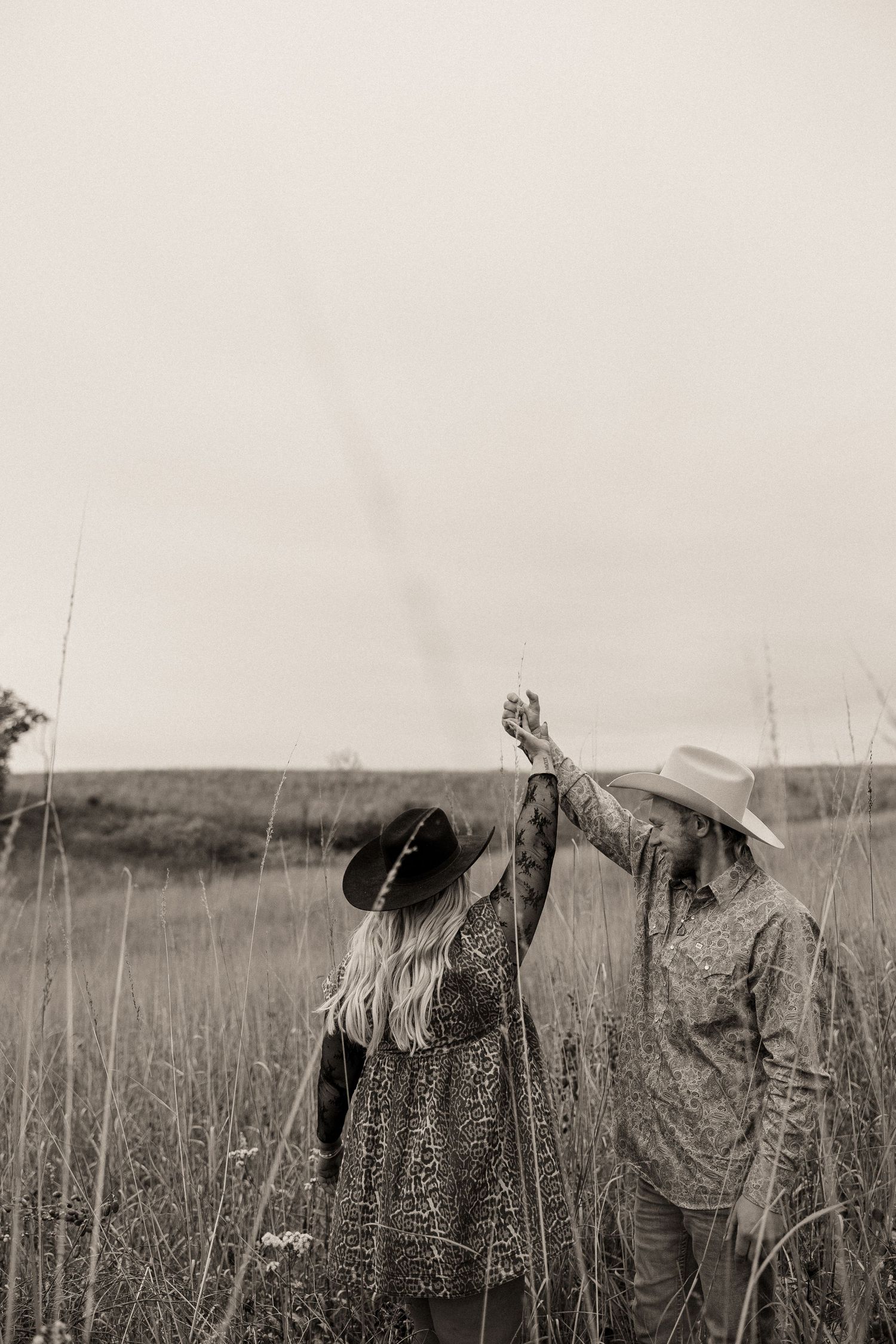 A vintage black and white photograph shows duck hunters crouching in tall grass with their hunting gear.