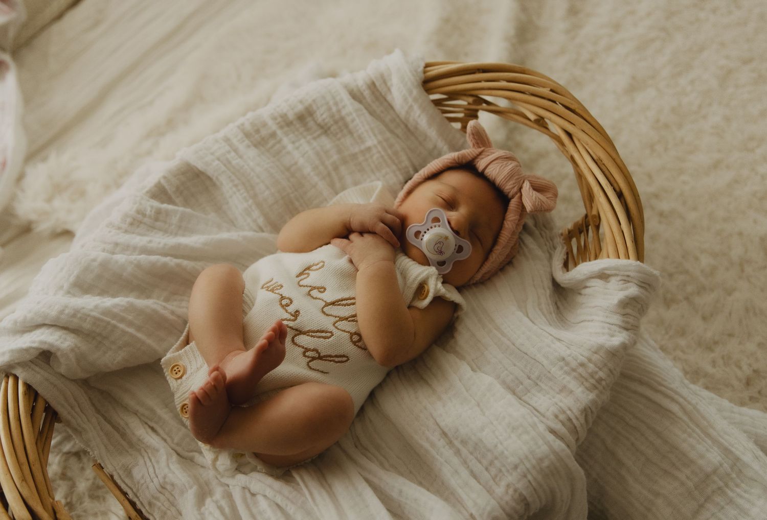 Baby's tiny feet nestled in soft white fabric with natural lighting.