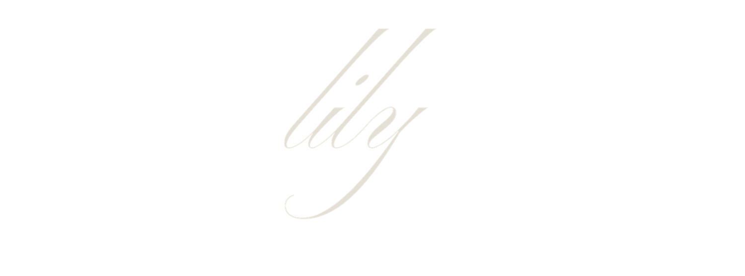 Elegant silver cursive handwriting showing the lowercase letter 'h' in a flowing calligraphic style.