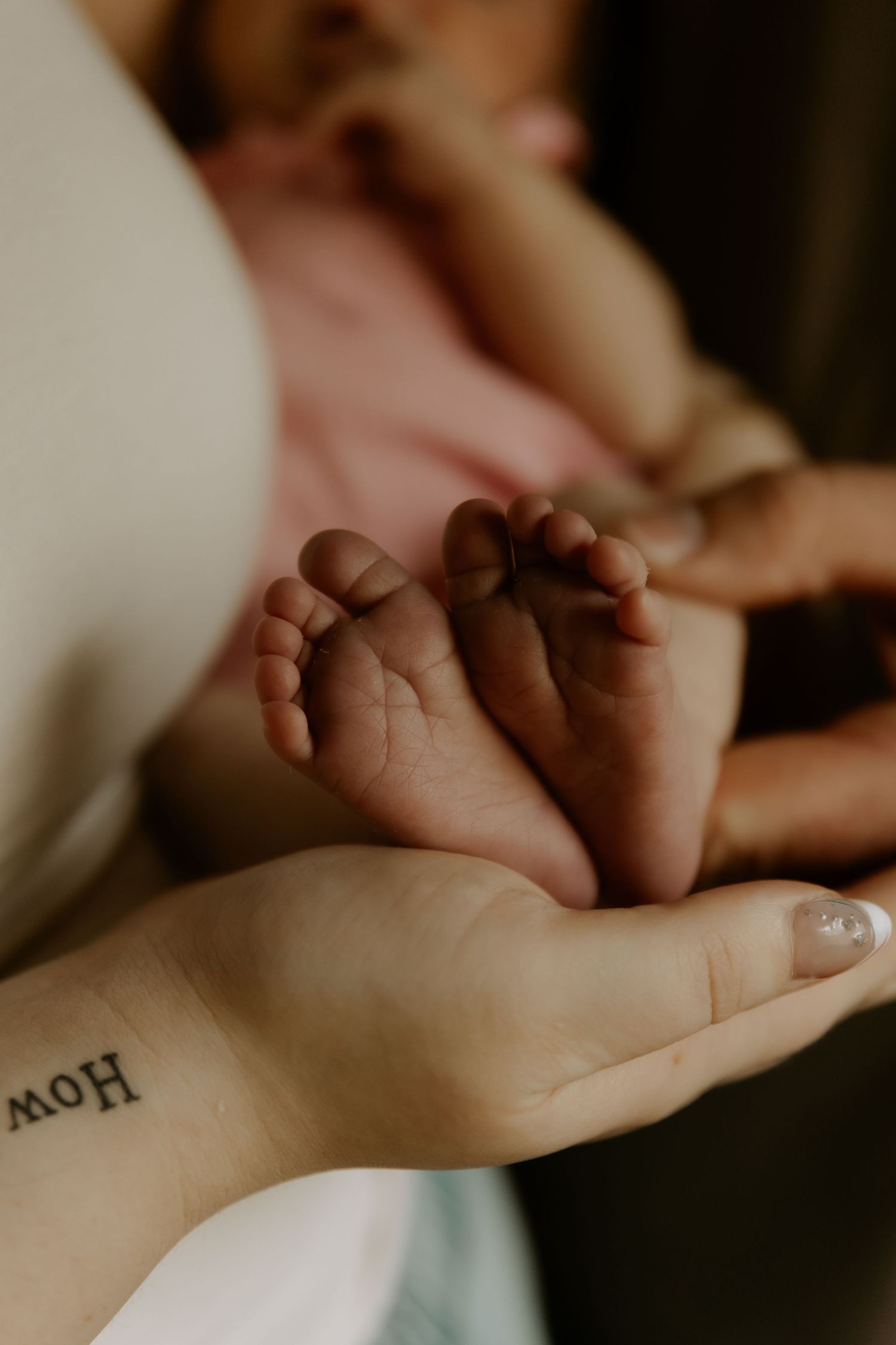 Close-up detail of gentle hands resting together in natural window light.