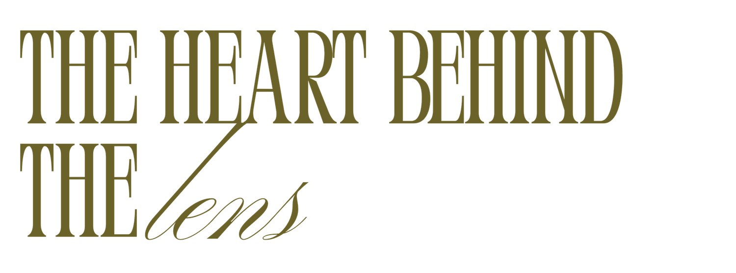 Decorative text showing 'THE HEART BEHIND' in elegant gold script lettering against a white background.