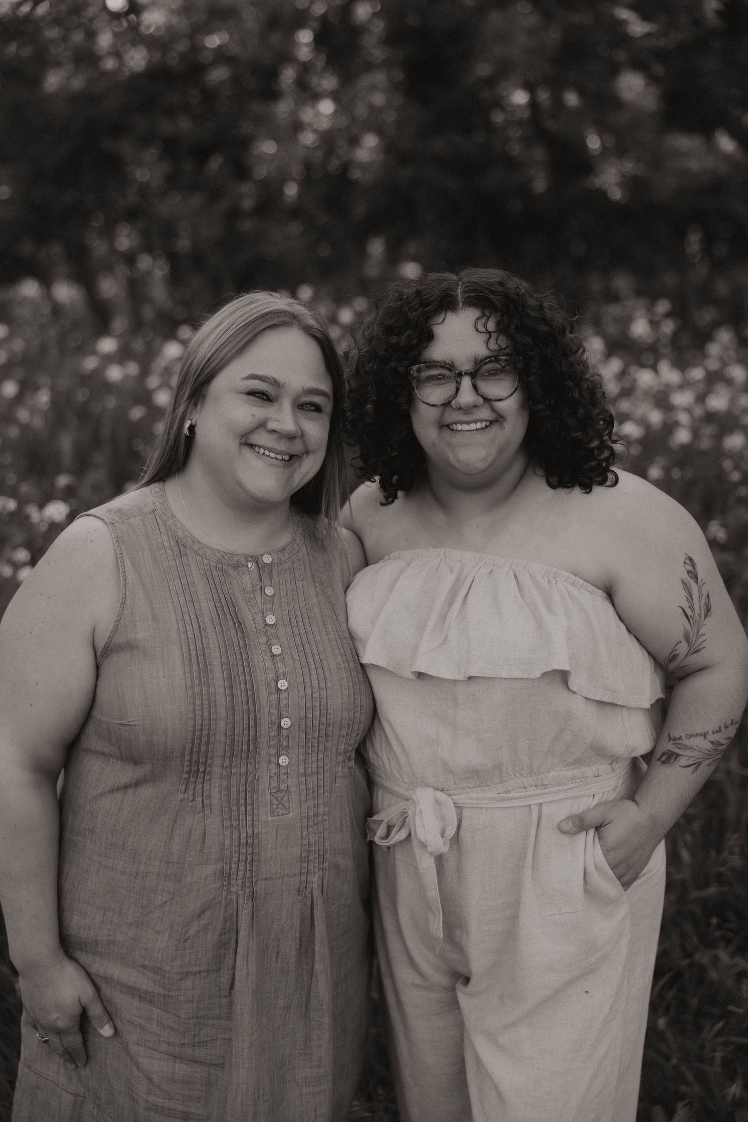 A black and white photo series showing two people in casual outfits posing together outdoors.