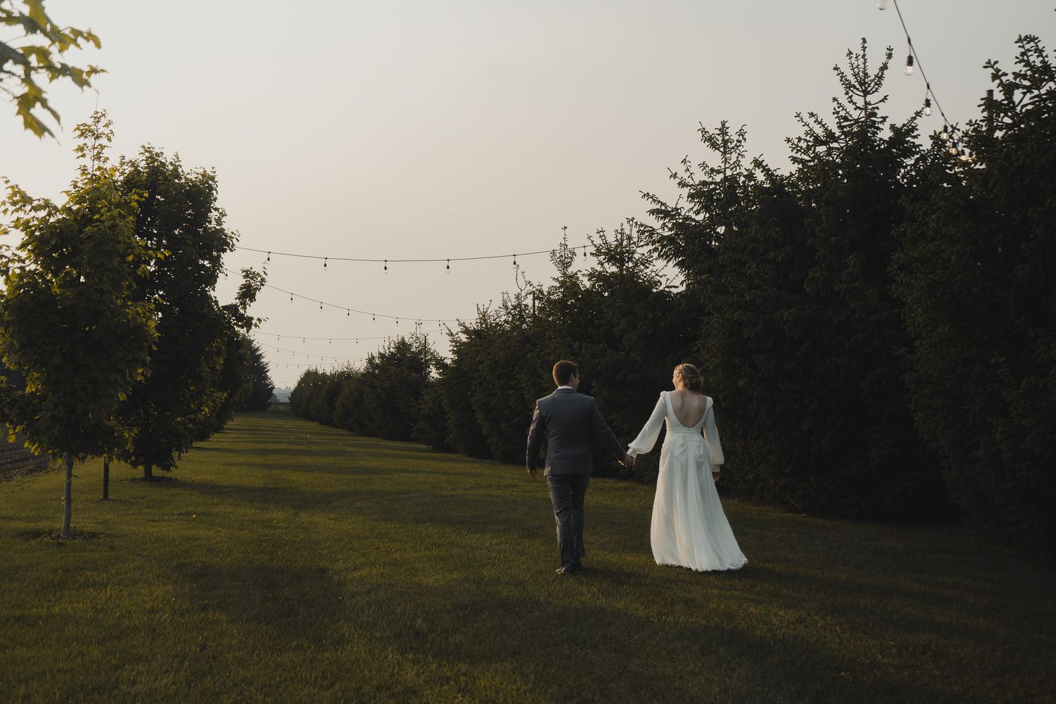 couple walking in field, Erin Ontario Wedding, james Glac Photography