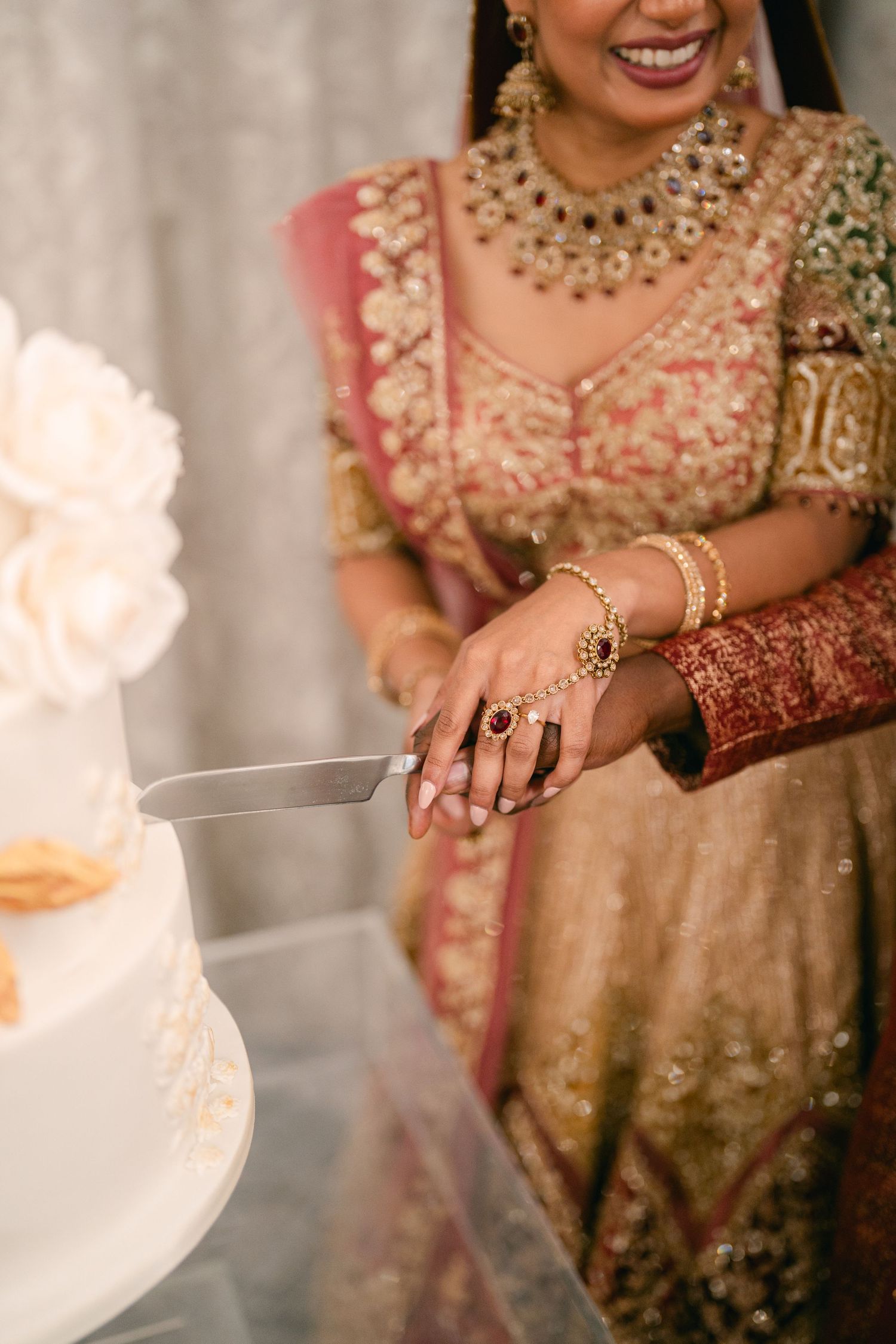 Close-up shot of intricate bridal jewelry and traditional wedding attire details.