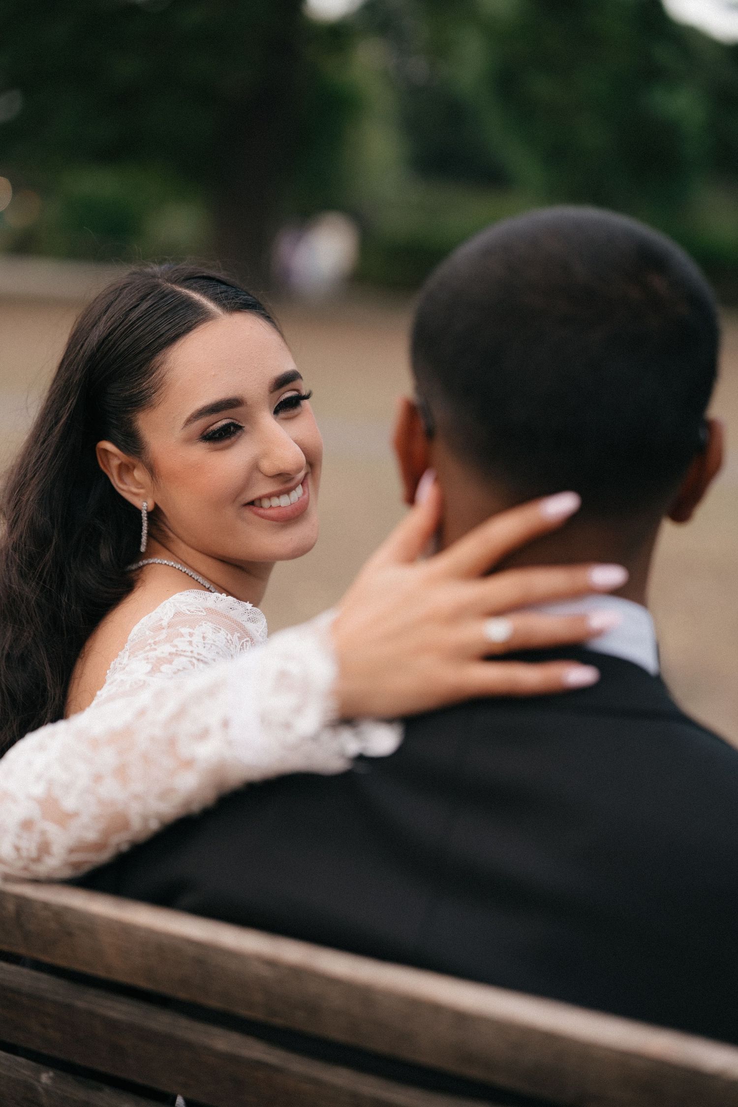 Intimate wedding portraits showing tender moments between newlyweds on a wooden bench.